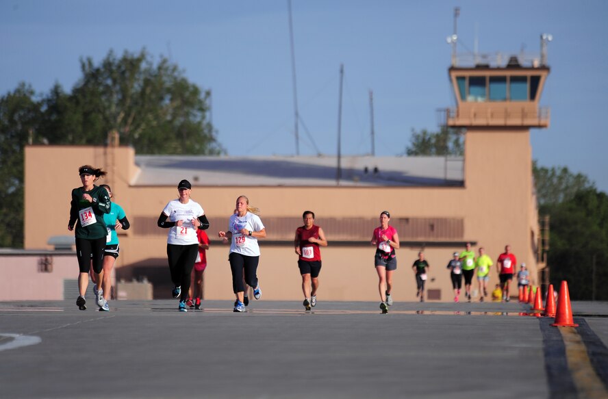 Participants make their way down the flightline while running in the annual Bellevue-Offutt Runway Run at Offutt Air Force Base, Neb., May 13.  Nearly 200 runners participated in this year's event, which is a unique, seven mile race that takes runners past parked aircraft and through the historic parade grounds and housing area. (U.S. Air Force Photo by Josh Plueger)