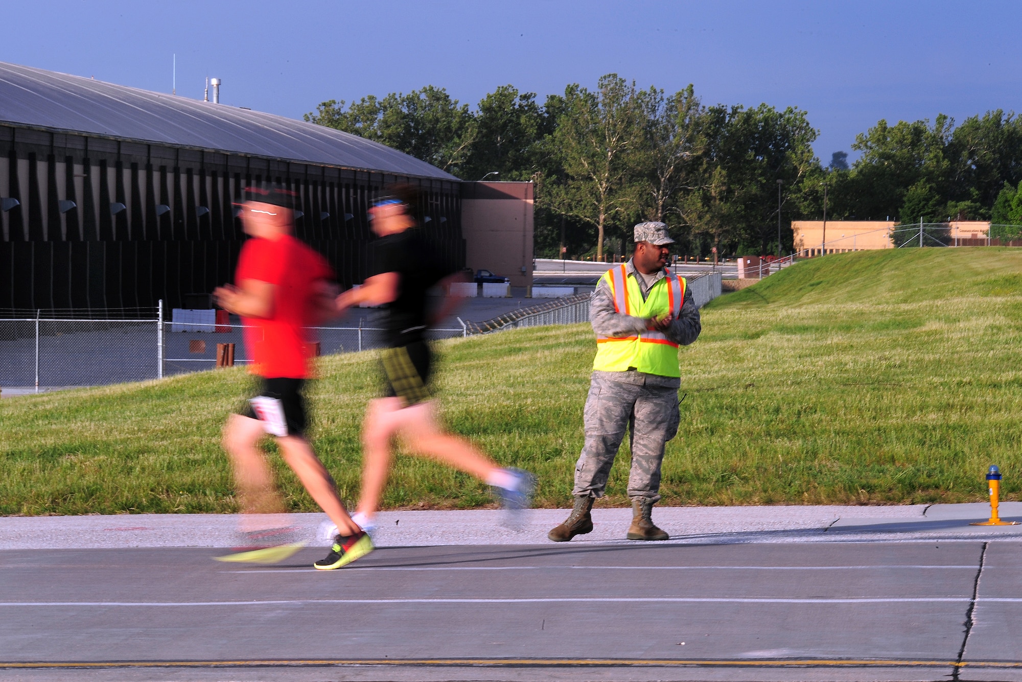 Participants make their way down the flightline while participating in the annual Bellevue-Offutt Runway Run at Offutt Air Force Base, Neb., May 13. The annual Mother's Day run is a unique, seven mile race that takes runners past parked aircraft and through the historic parade grounds and housing area.  (U.S. Air Force Photo by Josh Plueger)