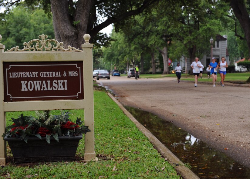 Participants run through base housing during the inaugural Mighty Eighth 8 Miler on Barksdale Air Force Base, La., May 12. The event, which included a 5k and an eight-mile run, was open to all authorized base personnel and sponsored guests. The eight-mile course started at the 2nd Security Forces Squadron, went to the 307th Bomb Wing and back to the 2 SFS building. (U.S. Air Force photo/Airman 1st Class Benjamin Gonsier)(RELEASED)
