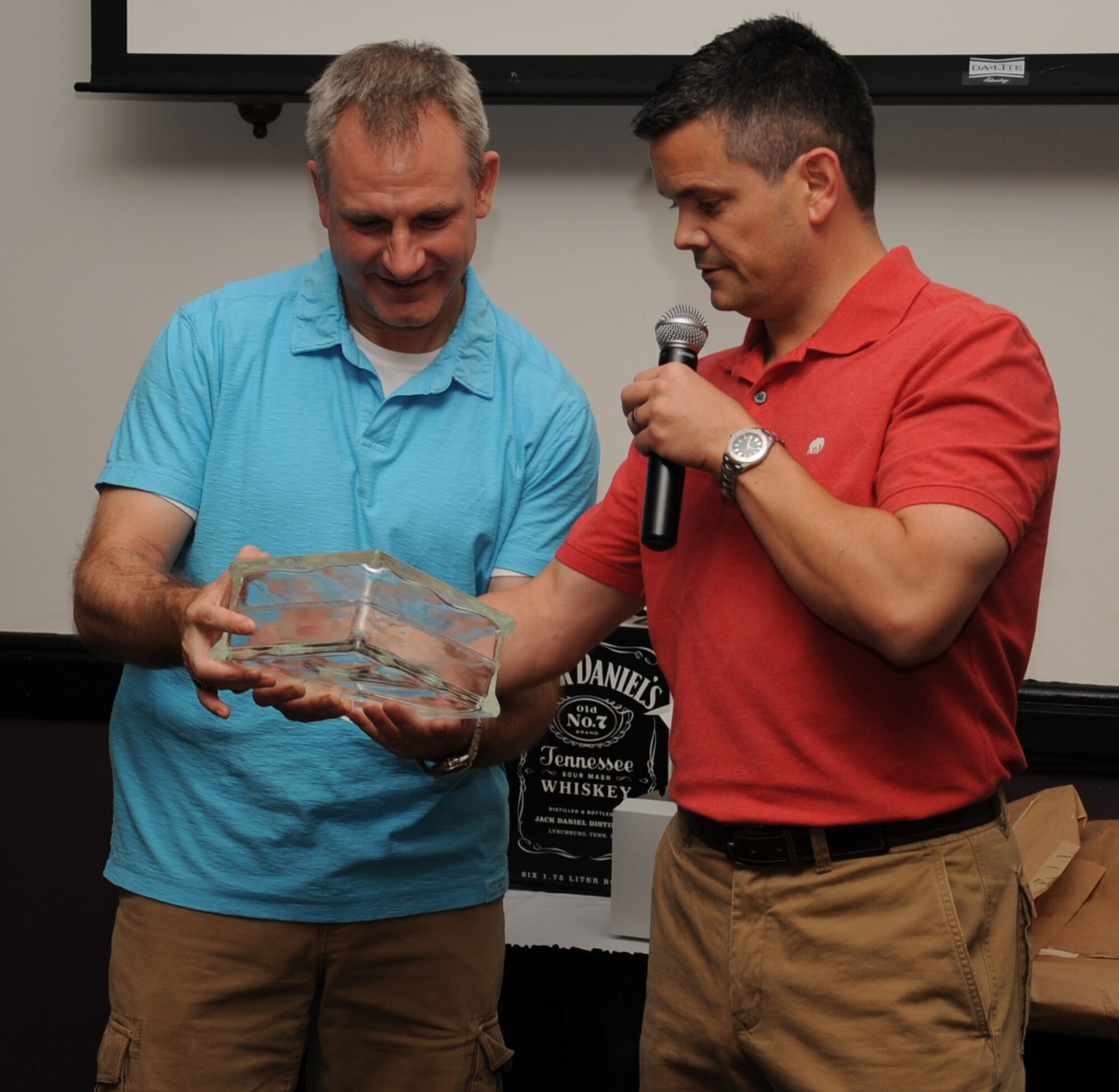 Lt. Col. Mike Thompson, 2nd Bomb Wing director of staff, presents Col. Tim Fay, 2 BW commander with a gift during a farewell dinner on Barksdale Air Force Base, La., May 11. Fay was 2 BW commander for nearly two years and moves on to his next assignment at the Pentagon. (U.S. Air Force photo/Senior Airman Sean Martin)(RELEASED)