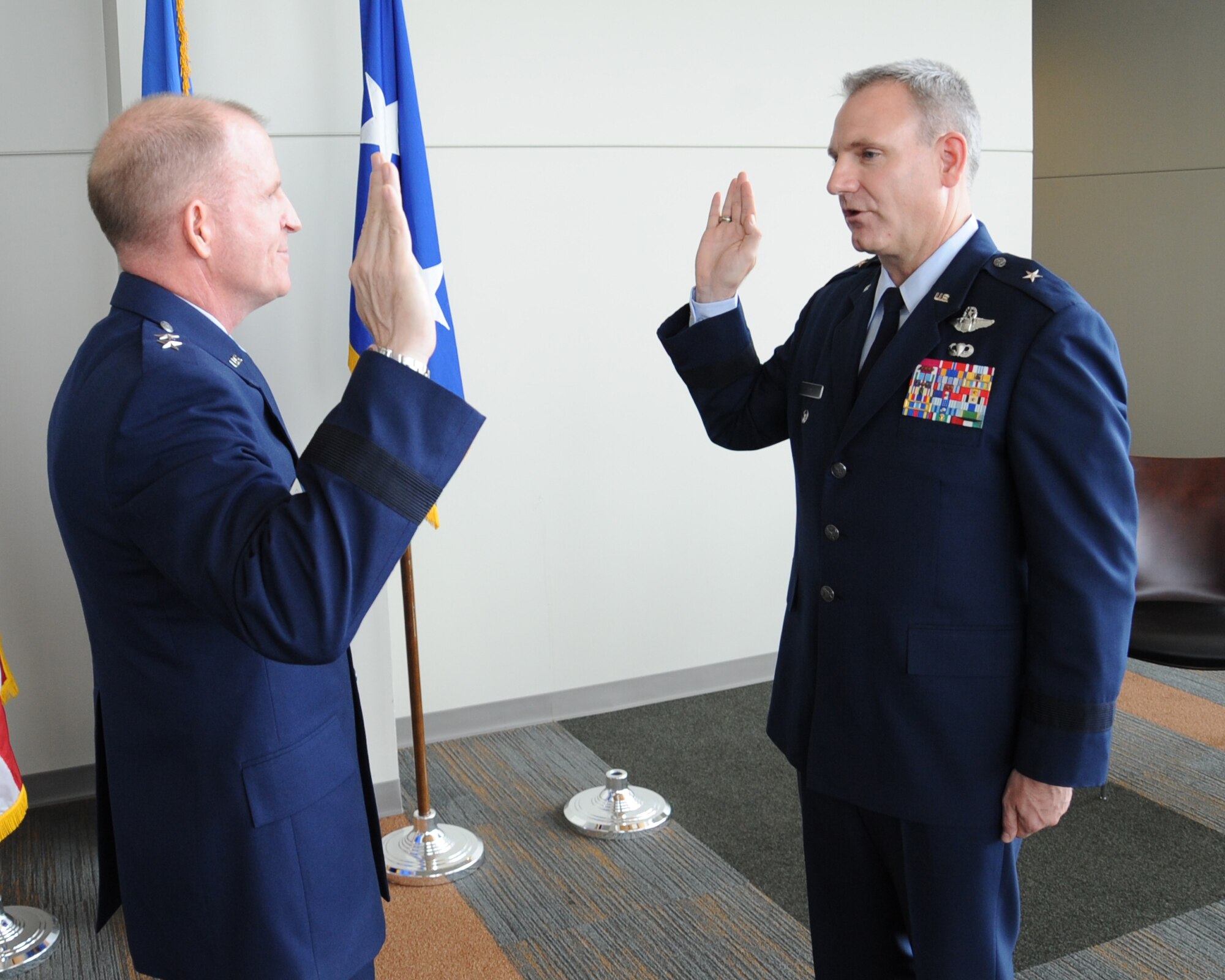 Maj. Gen. Stephen Wilson, 8th Air Force commander, administers the oath of office to Brig. Gen. Tim Fay, outgoing 2nd Bomb Wing commander, during his promotion ceremony at the Cyber Innovation Center in Bossier City, La., May 14. Fay will be heading to the Pentagon after serving as the Barksdale Air Force Base commander for two years. (U.S. Air Force photo/Senior Airman Sean Martin)(RELEASED)
