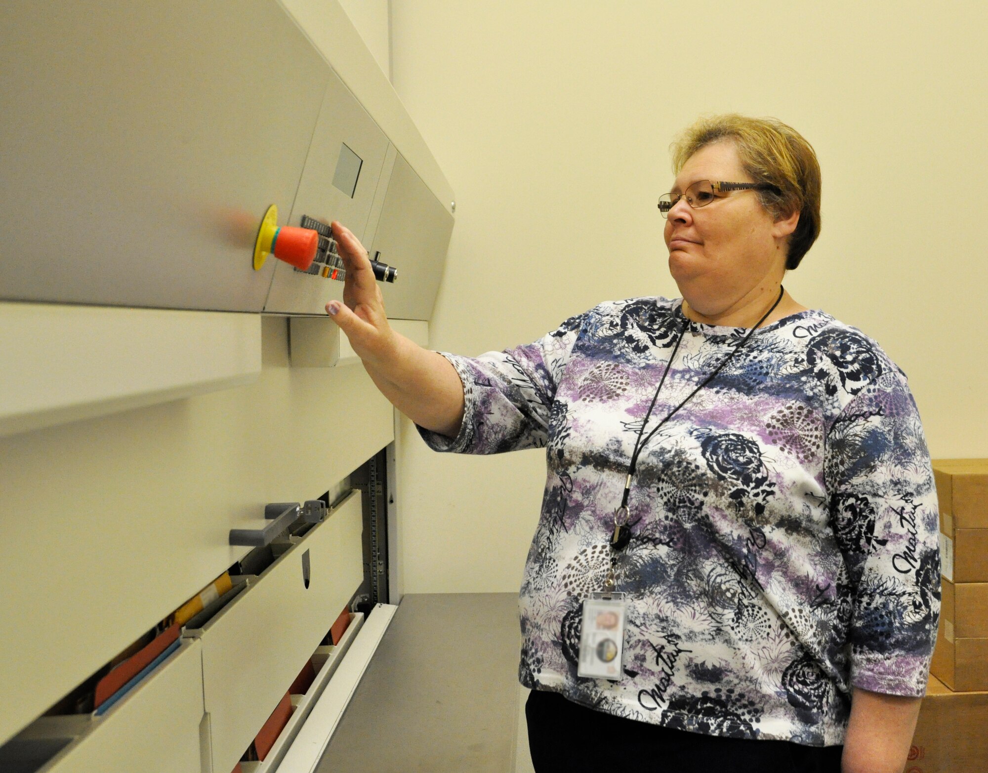 Charlotte Smart searches for a case file of a fallen service member in the 26-drawer file system May 10, 2012 in the file room at the Charles C. Carson Center for Mortuary Affairs, Dover Air Force Base, Del. As part of the administrative section in the Port Mortuary Branch, Smart, Deborah Murphy and Cynthia Boye-Smith are responsible for creating and filing hard copy and electronic case files. (U.S. Air Force photo/Tech. Sgt. Myco Apat)