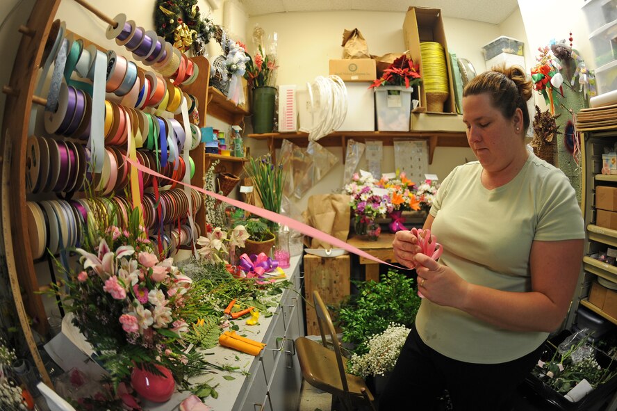 Brandy Daingerfield, Petals and Blooms floral designer, makes a bow at the flower shop on Seymour Johnson Air Force Base, N.C., May 11, 2012. The flower shop offers pick-up or same-day delivery. Daingerfield, spouse of U.S. Air Force Tech. Sgt. Michael Daingerfield, 4th Communications Squadron NCO in-charge of infrastructure, is from Woodbury, Tenn. (U.S. Air Force photo/Airman 1st Class John Nieves Camacho/Released)