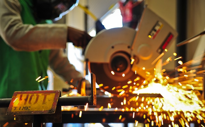 Airman 1st Class Tashma Antoine, an aircraft metals apprentice with the 437th Maintenance Squadron out of Joint Base Charleston, S.C., cuts a steel rod with an abrasive saw to fulfill training requirements May 9, 2012. Antoine works in the aircraft metals fabrication shop where he uses several different pieces of equipment to bend, cut and combine metals together. Antoine is originally from Fort Myers, Fla. (U.S. Air Force photo/Airman 1st Class Dennis Sloan)