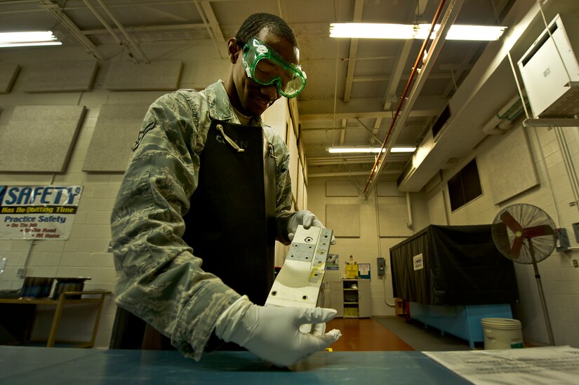 Airman 1st Class James Rogers, a non-destructive inspector with the 437th Maintenance Squadron out of Joint Base Charleston, S.C., demonstrates the use of the penetrate inspection line May 9, 2012. The inspection line uses chemicals and ultraviolet lights to detect cracks and flaws in metal. (U.S. Air Force photo/Airman 1st Class George Goslin)