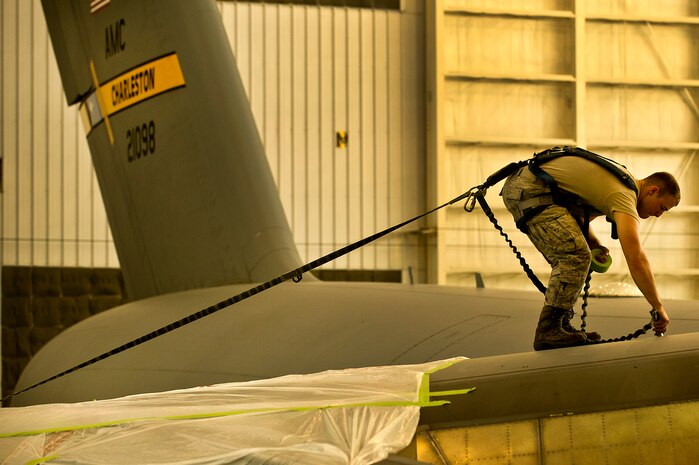 Airman 1st Class Justin Marcum, an aircraft metals technology apprentice with the 437th Maintenance Squadron out of Joint Base Charleston, S.C., masks parts of a C-17 Globemaster III before being painted May 9, 2012. The Airmen mask parts of the C-17 to prevent them from being painted with the rest of the plane. (U.S. Air Force photo/Airman 1st Class George Goslin)