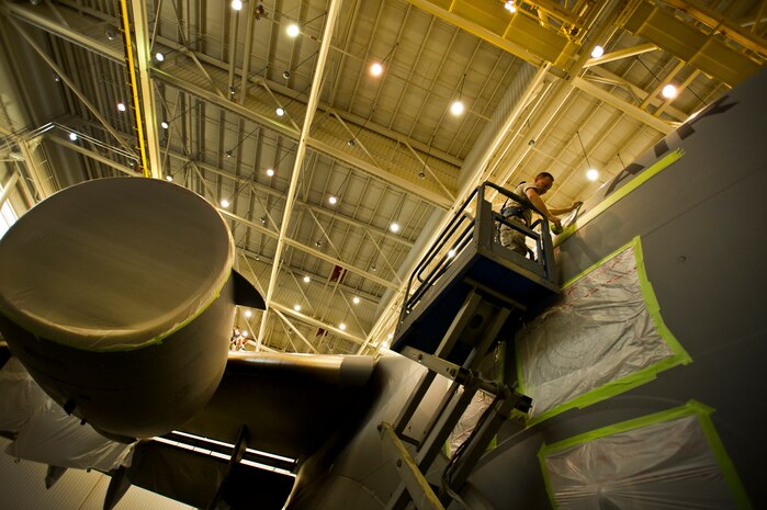 Air Force Reserve Staff Sgt. James Jordan, an aircraft metals technology craftsman with the 315th Maintenance Squadron out of Joint Base Charleston, S.C., masks parts of a C-17 Globemaster III before being painted May 9, 2012. The Airmen mask parts of the C-17 to prevent them from being painted with the rest of the plane. (U.S. Air Force photo/Airman 1st Class George Goslin)