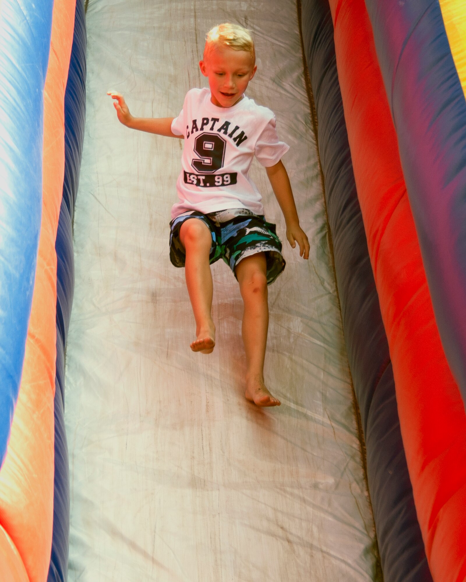 Christian Bulliard, son of Capt. Reese Bulliard, bounces down the inflatable slide set up at the 403rd Wing's Family Day May 5. (U.S. Air Force photo by Maj. Heather Newcomb)