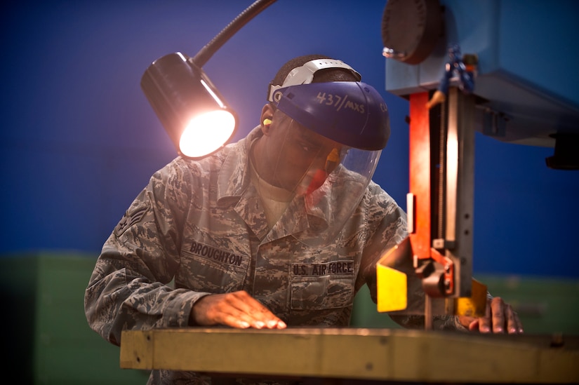 Senior Airman Tyrell Broughton, an aircraft metals technology journeyman with the 437th Maintenance Squadron out of Joint Base Charleston, S.C., cuts a sheet of metal with a bandsaw May 9, 2012. Aircraft metals specialists perform functions such as gas and electric welding, milling, machining, grinding metal, or using precision measuring devices. (U.S. Air Force photo/Airman 1st Class George Goslin)