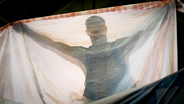 Airman 1st Class Justin Marcum, an aircraft metals technology apprentice with the 437th Maintenance Squadron out of Joint Base Charleston, S.C., stretches a sheet of plastic out to be used to cover sections of a C-17 Globemaseter III before being painted May 9, 2012. The Airmen mask parts of the C-17 to prevent them from being painted with the rest of the plane. Marcum is originally from Hamilton Ohio. (U.S. Air Force photo/Airman 1st Class Dennis Sloan)
