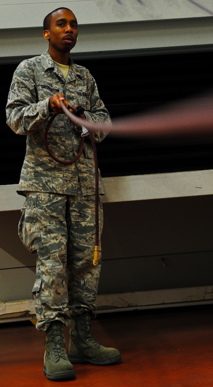 Senior Airman Tyrell Broughton, an aircraft metals technology journeyman with the 437th Maintenance Squadron out of Joint Base Charleston, S.C., pulls an air hose over to his work station to be attached to a drill May 9, 2012. Broughton is originally from Atlanta, Ga., and joined the Air Force because he wanted to serve his country and get an education. (U.S. Air Force photo/Airman 1st Class Dennis Sloan)