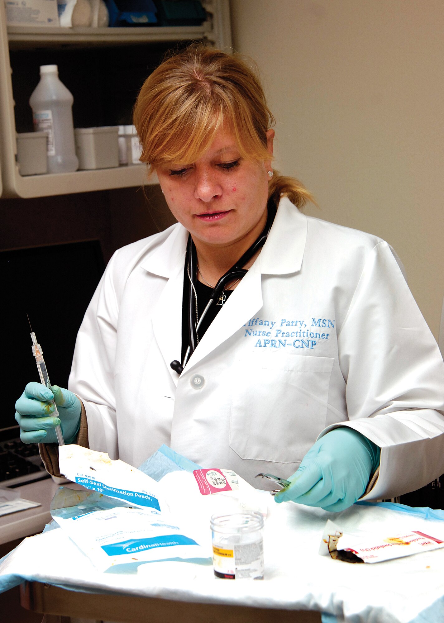 Nurse Practitioner Tiffany Parry prepares for a procedure in a treatment room of the 72nd Medical Group Clinic.  Nurse practitioners have more training than a registered nurse and can prescribe and perform certain procedures. (Air Force photo by Margo Wright)
