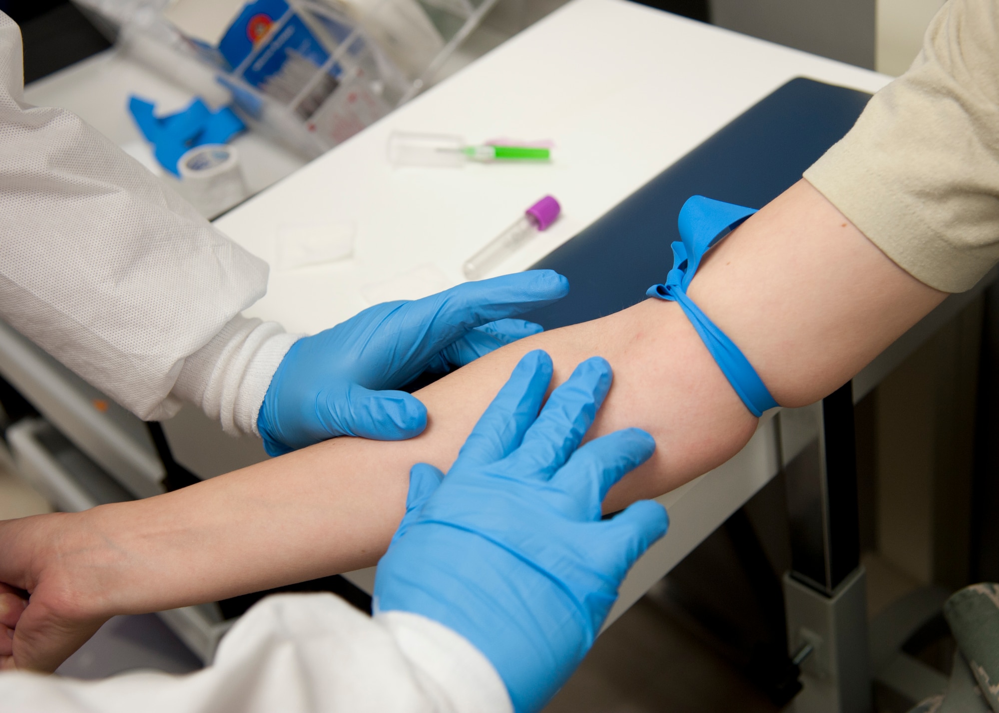 HOLLOMAN AIR FORCE BASE, N.M. — Airman 1st Class Devin Adrian, 49th Medical Support Squadron laboratory technician, checks for a vein on an Airman’s arm before he draws blood April 25 at the medical laboratory clinic. In the lab each Airman manages a section – shipping, chemistry, hematology, and the front desk. The Airmen rotate through each section to be knowledgeable on everything. The medical laboratory mission is to take samples of biological materials and then assess the cells to gather the results doctors need to make diagnoses of their patients. (U.S. Air Force photo by Airman 1st Class Colin Cates/Released)