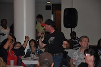 Jeremy Egg, a civilian in the 902nd Civil Engineer Squadron resources office and third-place finisher, sings to the audience during the Randolph Idol finale event May 4. (U.S. Air Force photo by Chris Anderson)