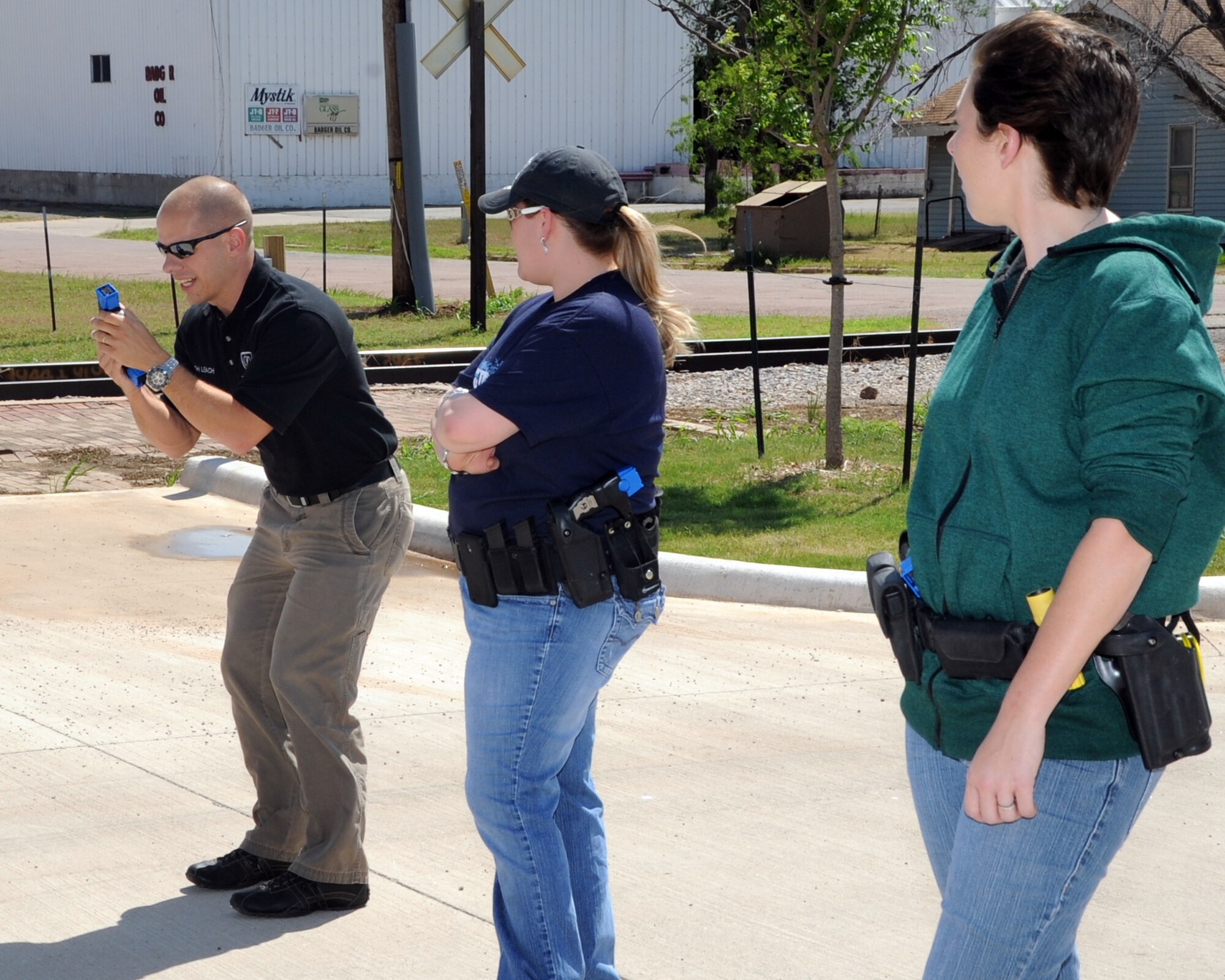 ALTUS, Okla. -- Joshua Leach, 97th Security Forces Squadron lead investigator and master Taser instructor, demonstrates how to reload a Taser cartridge for members of the City of Altus Police Department during a Taser training May 1, 2012 at the Altus Police Department. Leach is a certified master Taser instructor and recently re-certified 27 Altus police officers, which saved the city approximately $10,000. (U.S. Air Force photo by Airman 1st Class Kenneth W. Norman / Released / 97th Air Mobility Wing Public Affairs)