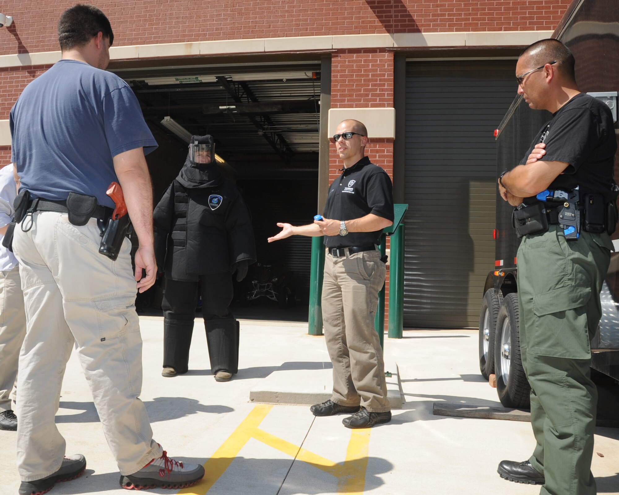 ALTUS, Okla. -- Joshua Leach, 97th Security Forces Squadron lead investigator and master Taser instructor, talks with members of the City of Altus Police Department during a Taser training May 1, 2012 at the Altus Police Department. Leach is a certified master Taser instructor and recently re-certified 27 Altus police officers, which saved the city approximately $10,000. (U.S. Air Force photo by Airman 1st Class Kenneth W. Norman / Released / 97th Air Mobility Wing Public Affairs)