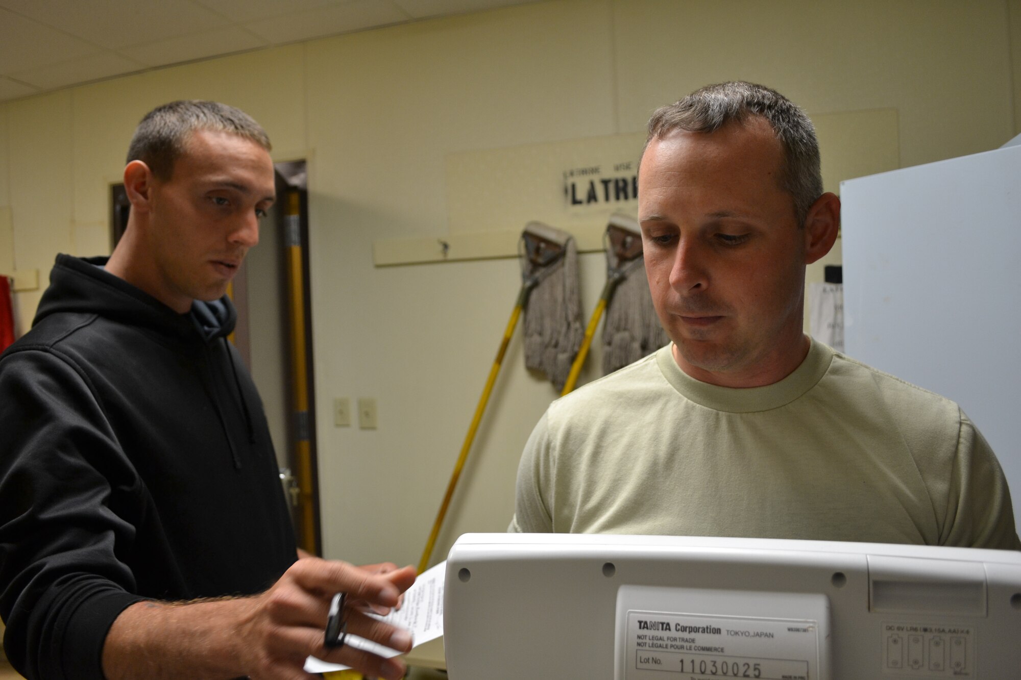 U.S. Army Staff Sgt. Christopher Payne (right), a Special Troops Battalion, 7th Sustainment Brigade medic, weighs in at the Fort Eustis Combatives Academy May 11, 2012. He fought the following day in the Fort Eustis Combatives Tournament at McClellan Fitness Center. (U.S. Army photo by Staff Sgt. Alexander Burnett/Released)