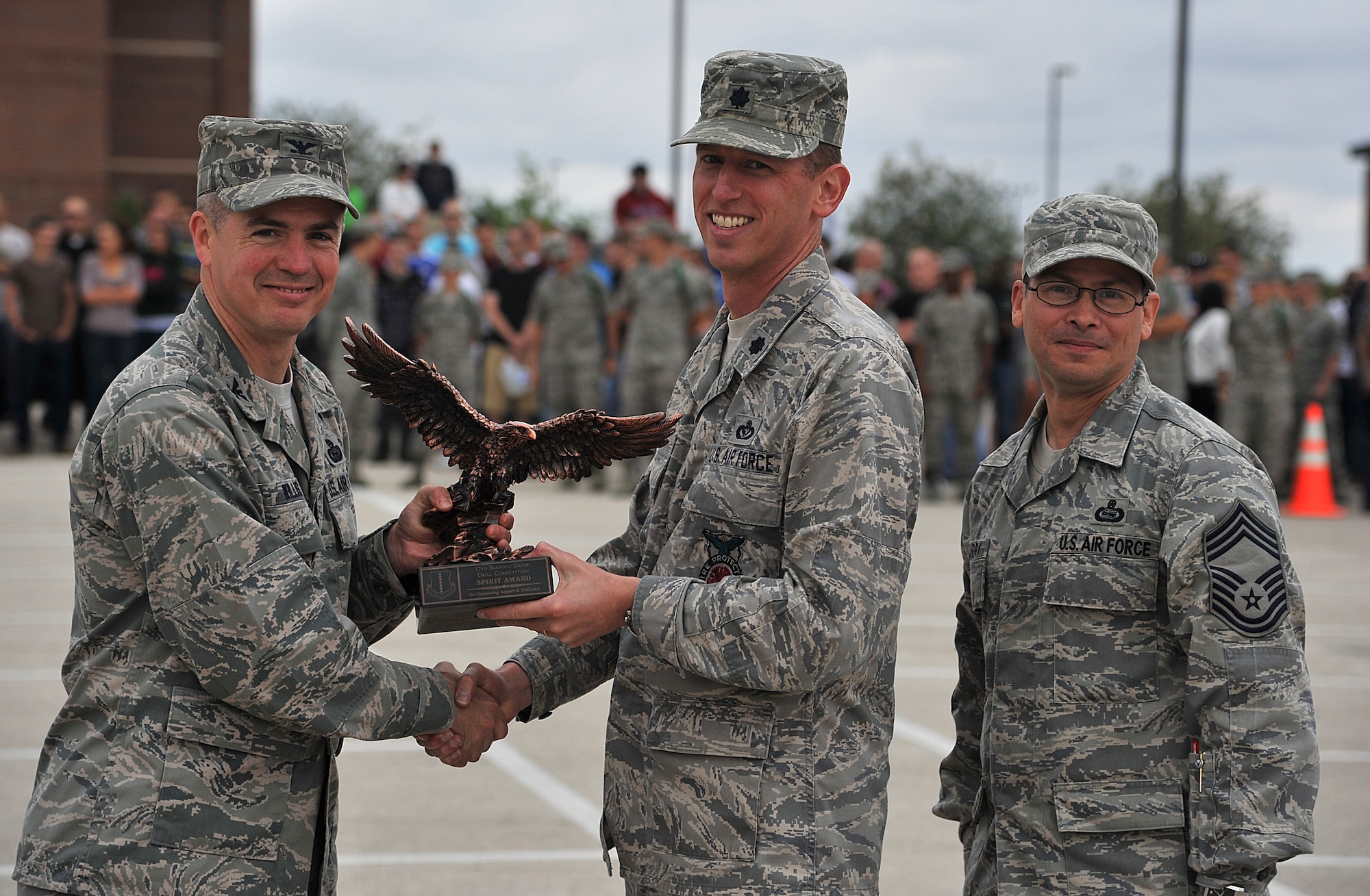 GOODFELLOW AIR FORCE BASE, Texas--Col. JD Willis, 17th Training Group Commander, and Chief Master Sgt. Raymond Irizarry, 17th TRG superintendent, present Lt. Col. Thomas Taylor, 312th Training Squadron Commander, with the spirit award for his squadron at the drill competition May 12. (U.S. Air Force photo/Airman 1st Class Michael Smith)
