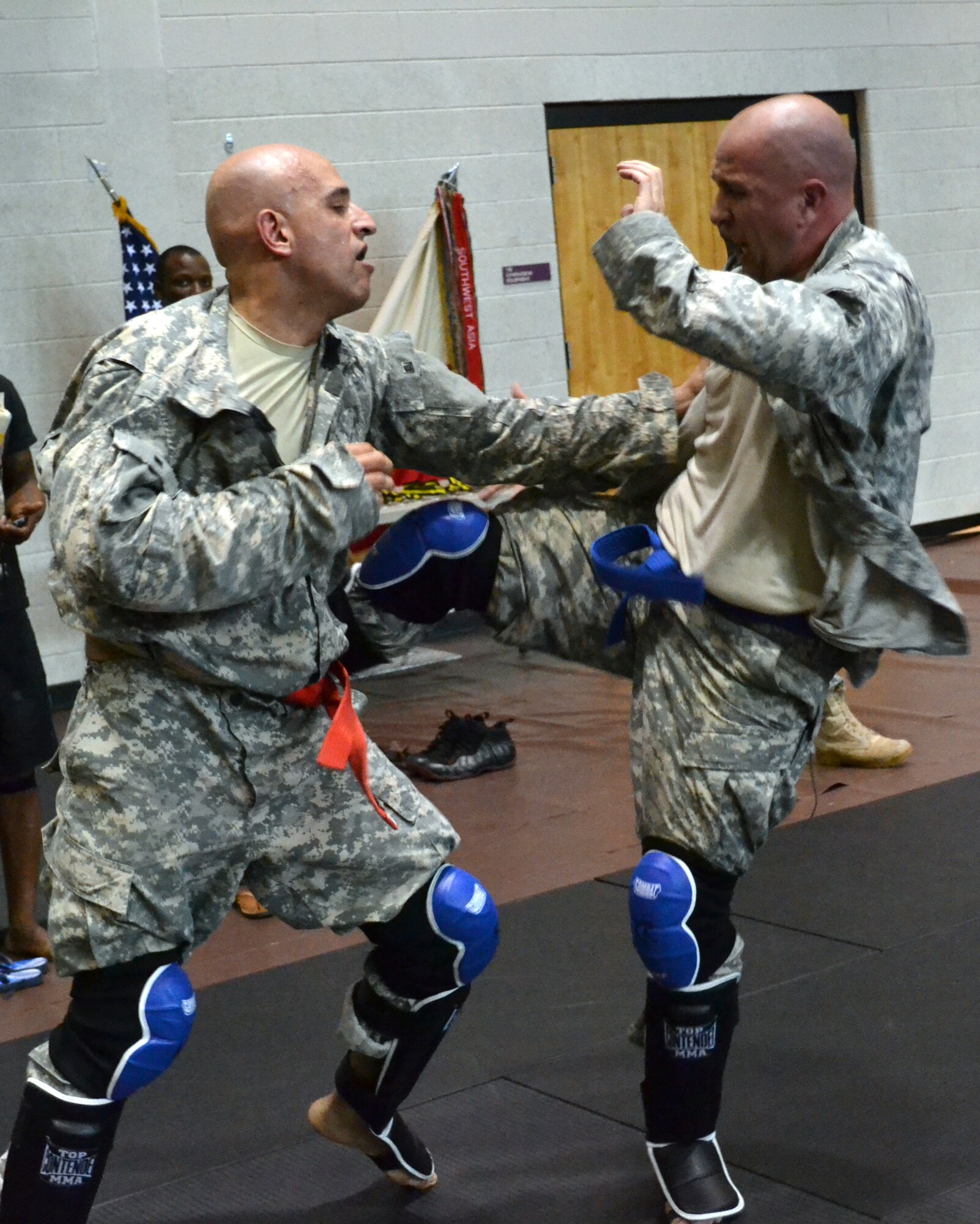 U.S. Army Spc. Moosa Limon (left), a transportation specialist assigned to the 386th Seaport Operations Company, 11th Transportation Battalion, 7th Sustainment Brigade, attempts to grab his competitor after being kicked in the side during the Fort Eustis Combatives Tournament at McClellan Fitness Center, May 12, 2012. Limon went on to win first place in the light heavyweight category. (U.S. Army photo by Staff Sgt. Alexander Burnett/Released)