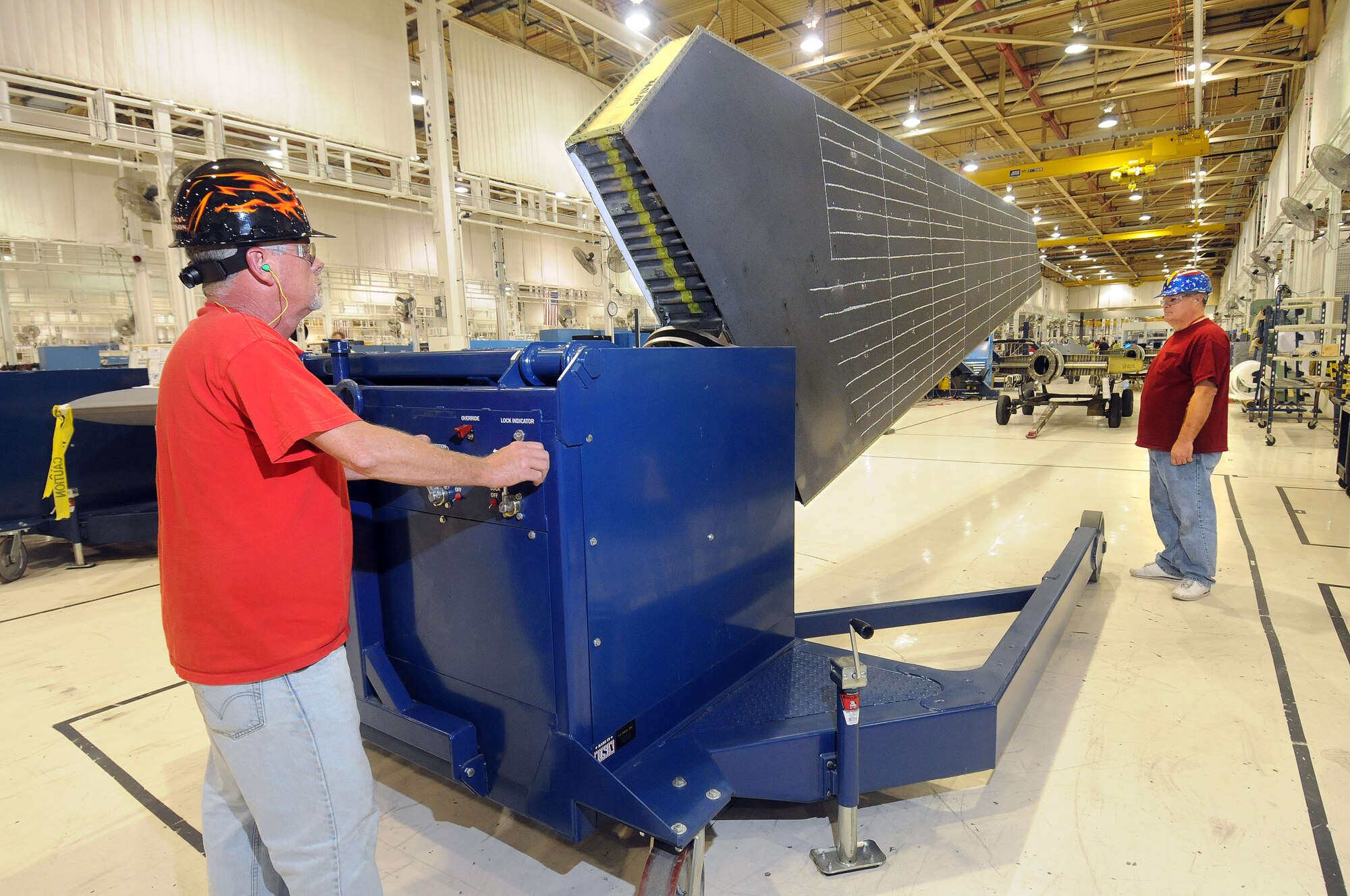 Preparing to rotate a B-1 stabilizer, using a new ergonomic work cart at the B-1 Stabilizer/Miscellaneous Shop in Bldg. 9001, are work leader Phil Brewer, left, and sheet metal mechanic Dennis Collins. (Air Force photo by Dave Faytinger)