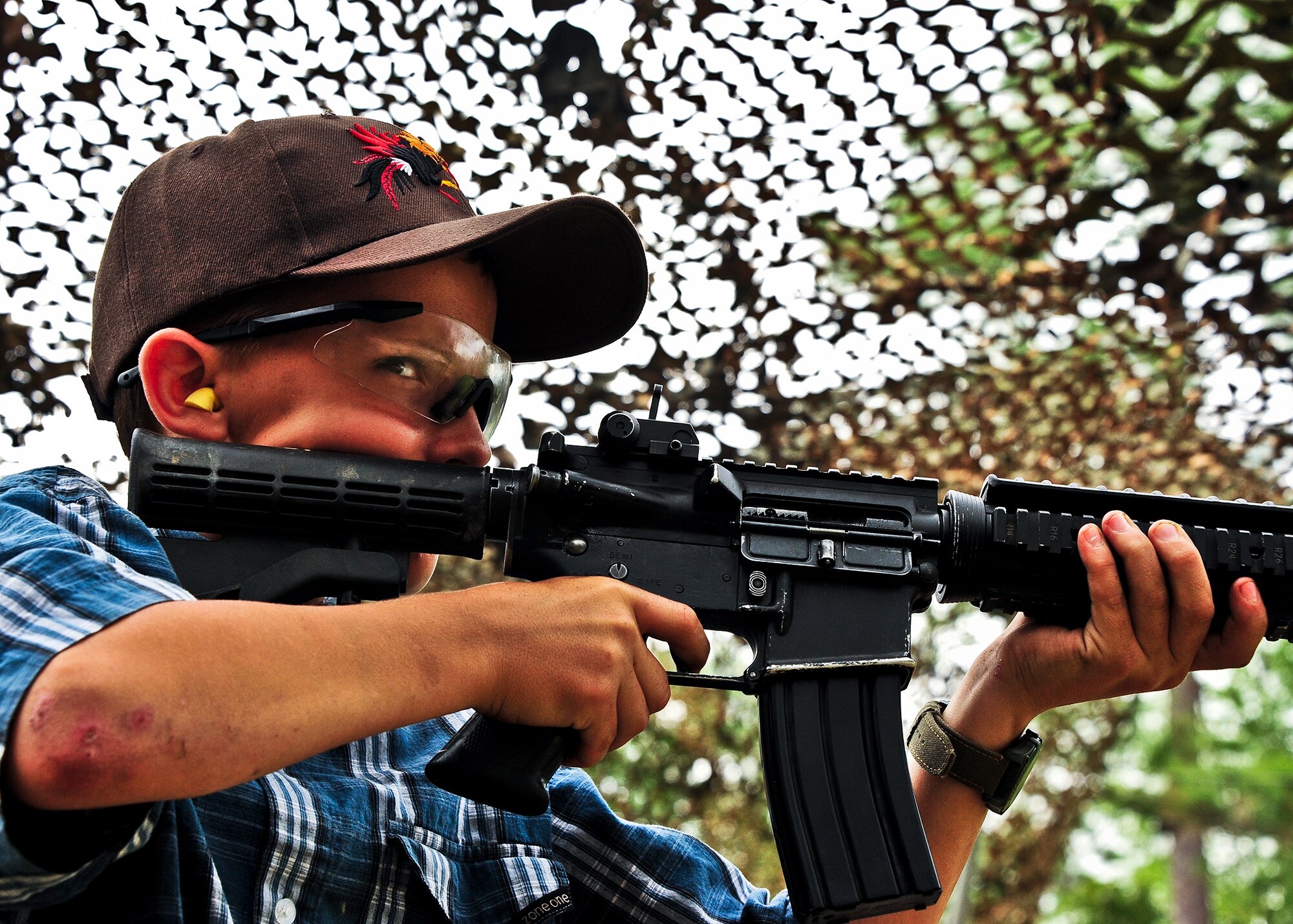 A future Army Ranger waits for the command to fire his M-4 at the 6th Ranger Training Battalion’s annual open house event, May 12 at Eglin Air Force Base, Fla.  The event was a chance for the public to learn how Rangers train and operate. The event displays showed dive equipment, weapons, a reptile zoo and zodiac boats among others. The demonstrations showed off hand-to-hand combat, a parachute jump, a down-pilot scenario and others.  (U.S. Air Force photo/Samuel King Jr.)