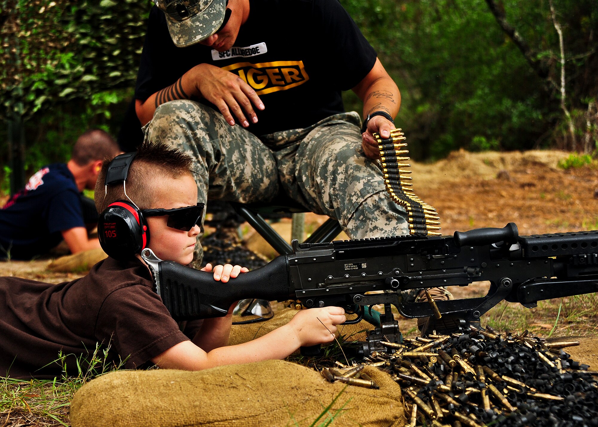 A future Army Ranger fires rounds from an M-240 at the 6th Ranger Training Battalion’s annual open house event, May 12 at Eglin Air Force Base, Fla.  The event was a chance for the public to learn how Rangers train and operate. The event displays showed dive equipment, weapons, a reptile zoo and zodiac boats among others. The demonstrations showed off hand-to-hand combat, a parachute jump, a down-pilot scenario and others.  (U.S. Air Force photo/Samuel King Jr.)