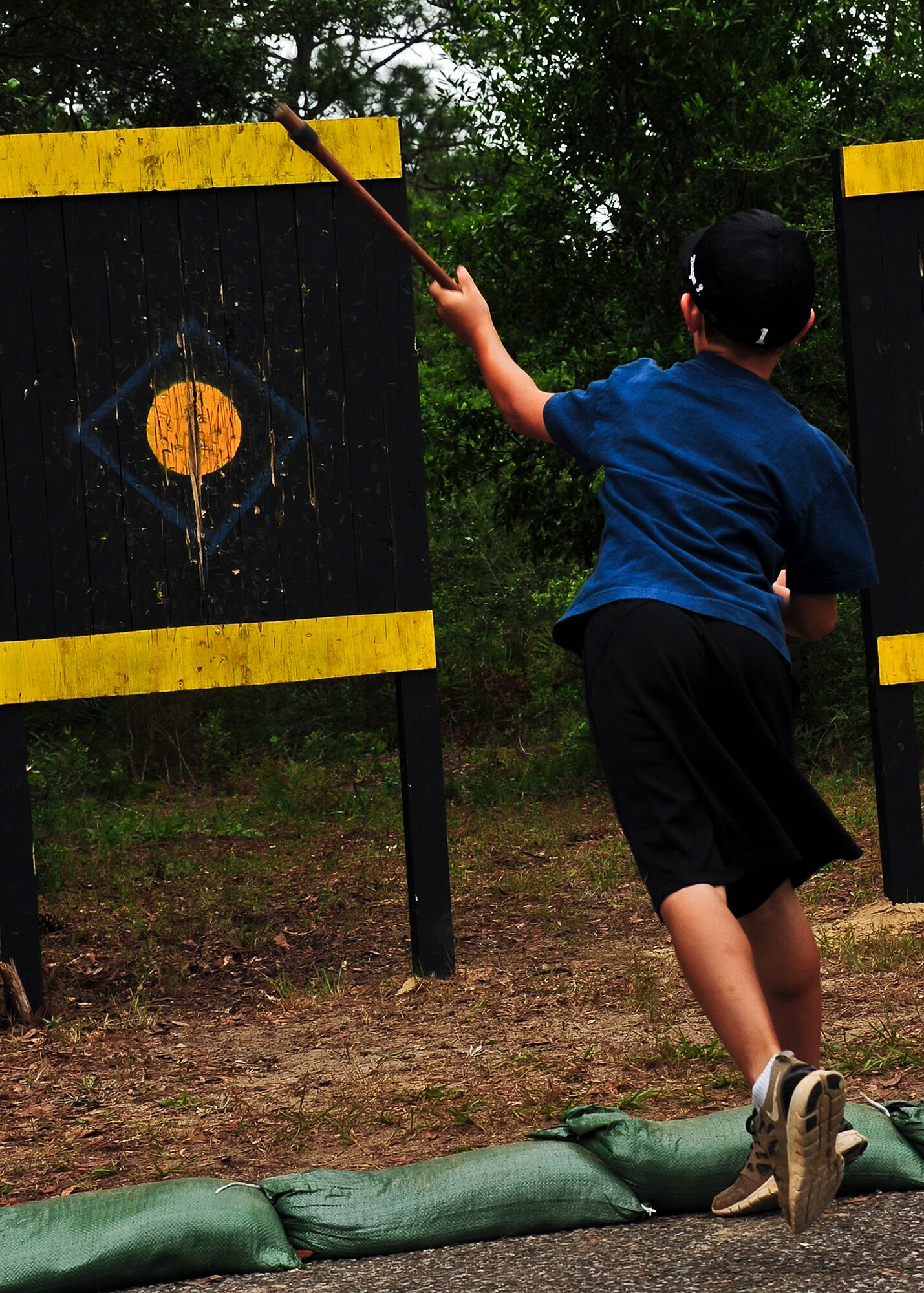A future Ranger hurls a hatchet at the target at one of the many interactive displays at the 6th Ranger Training Battalion’s annual open house event, May 12 at Eglin Air Force Base, Fla.  The event was a chance for the public to learn how Rangers train and operate. The event displays showed dive equipment, weapons, a reptile zoo and zodiac boats among others. The demonstrations showed off hand-to-hand combat, a parachute jump, a down-pilot scenario and others. (U.S. Air Force photo/Samuel King Jr.) 