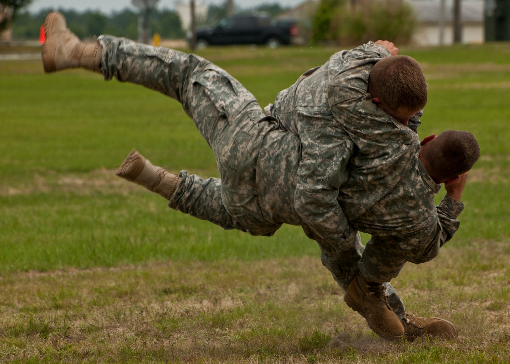 Rangers perform a take-down maneuver during a combative demonstration at the 6th Ranger Training Battalion’s annual open house event, May 12 at Eglin Air Force Base, Fla.  The event was a chance for the public to learn how Rangers train and operate. The event displays showed dive equipment, weapons, a reptile zoo and zodiac boats among others. The demonstrations showed off hand-to-hand combat, a parachute jump, a down-pilot scenario and others.  (U.S. Air Force photo/Samuel King Jr.)