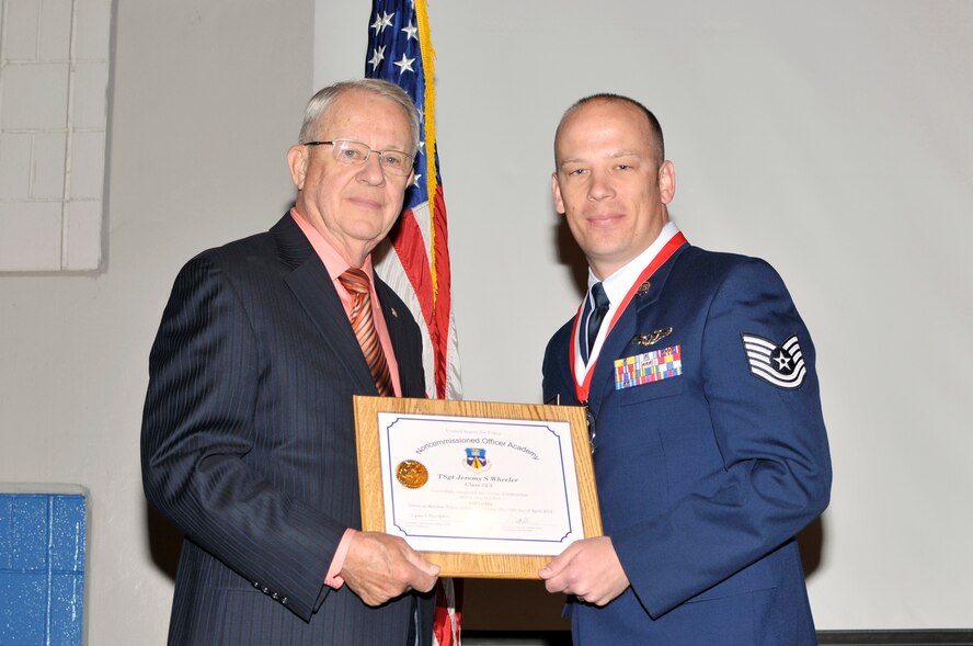 McGHEE TYSON AIR NATIONAL GUARD BASE, Tenn. - Tech. Sgt. Jeremy S. Wheeler, right, receives the distinguished graduate award for NCO Academy Class 12-3 at the I.G. Training and Education Center from retired Chief Master Sgt. "Doc" McCauslin, Air Force Sergeants Association, April 12, 2012. The distinguished graduate award is presented to students in the top ten percent of the class.  It is based on objective and performance evaluations, demonstrated leadership, and performance as a team player. (Air National Guard photo by Master Sgt. Kurt Skoglund/Released) 