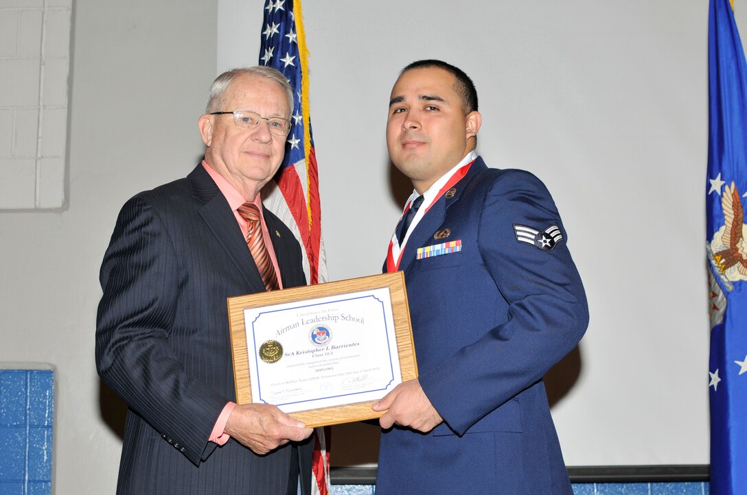 McGHEE TYSON AIR NATIONAL GUARD BASE, Tenn. - Senior Airman Kristopher L. Barrientes, right, receives the distinguished graduate award for Airman Leadership School Class 12-3 at The I.G. Brown Training and Education Center from retired Chief Master Sgt. "Doc" McCauslin, Air Force Sergeants Association, April 12, 2012. The distinguished graduate award is presented to students in the top ten percent of the class.  It is based on objective and performance evaluations, demonstrated leadership, and performance as a team player. (Air National Guard photo by Master Sgt. Kurt Skoglund/Released) 