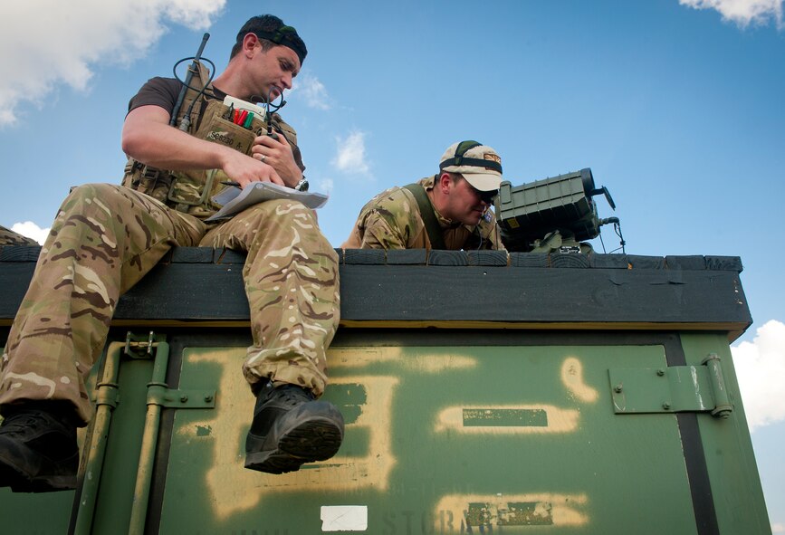 British army Sgt. (Tech. Sgt.) Lee Scaramuzza, 29th Commando Regiment joint terminal attack controller, reads target information as British army Sgt. (U.S. Army Staff Sgt.) Neil Clarke, 29th Commando Regiment JTAC, uses a Laser Rangefinder 28 (LF28) to mark a target for an A-10C Thunderbolt II at Grand Bay Bombing and Gunnery Range, Ga., May 8, 2012. The LF28 emits an infrared laser, which helps guide bombs to their target.  (U.S. Air Force photo by Airman 1st Class Jarrod Grammel/Released)
