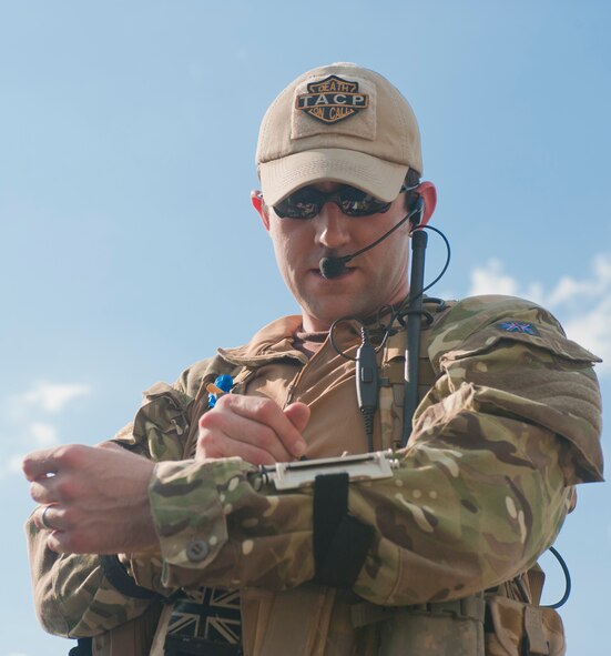 Royal Air Force Flight Lieutenant (Capt.) Richard May, 1st Armored Division master joint terminal attack controller, records communications between the aircraft and JTACs at Grand Bay Bombing and Gunnery Range, Ga., May 8, 2012. The JTACs write down target data and other information, such as landmarks, to help themselves and pilots properly identify targets. (U.S. Air Force photo by Airman 1st Class Jarrod Grammel/Released)
