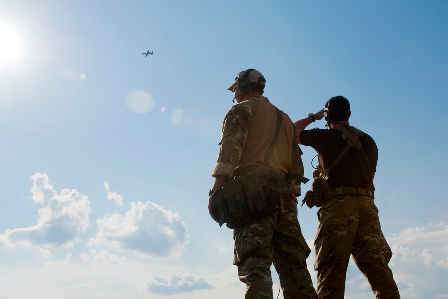 British army Sgts. (Tech. Sgts.) Lee Scaramuzza and Neil Clarke, joint terminal attack controllers with the 29th Commando Regiment, watch an A-10C Thunderbolt II fly over Grand Bay Bombing and Gunnery Range, Ga., May 8, 2012. British JTACs routinely work with U.S. Air Force and Navy aircraft while deployed. (U.S. Air Force photo by Airman 1st Class Jarrod Grammel/Released)
