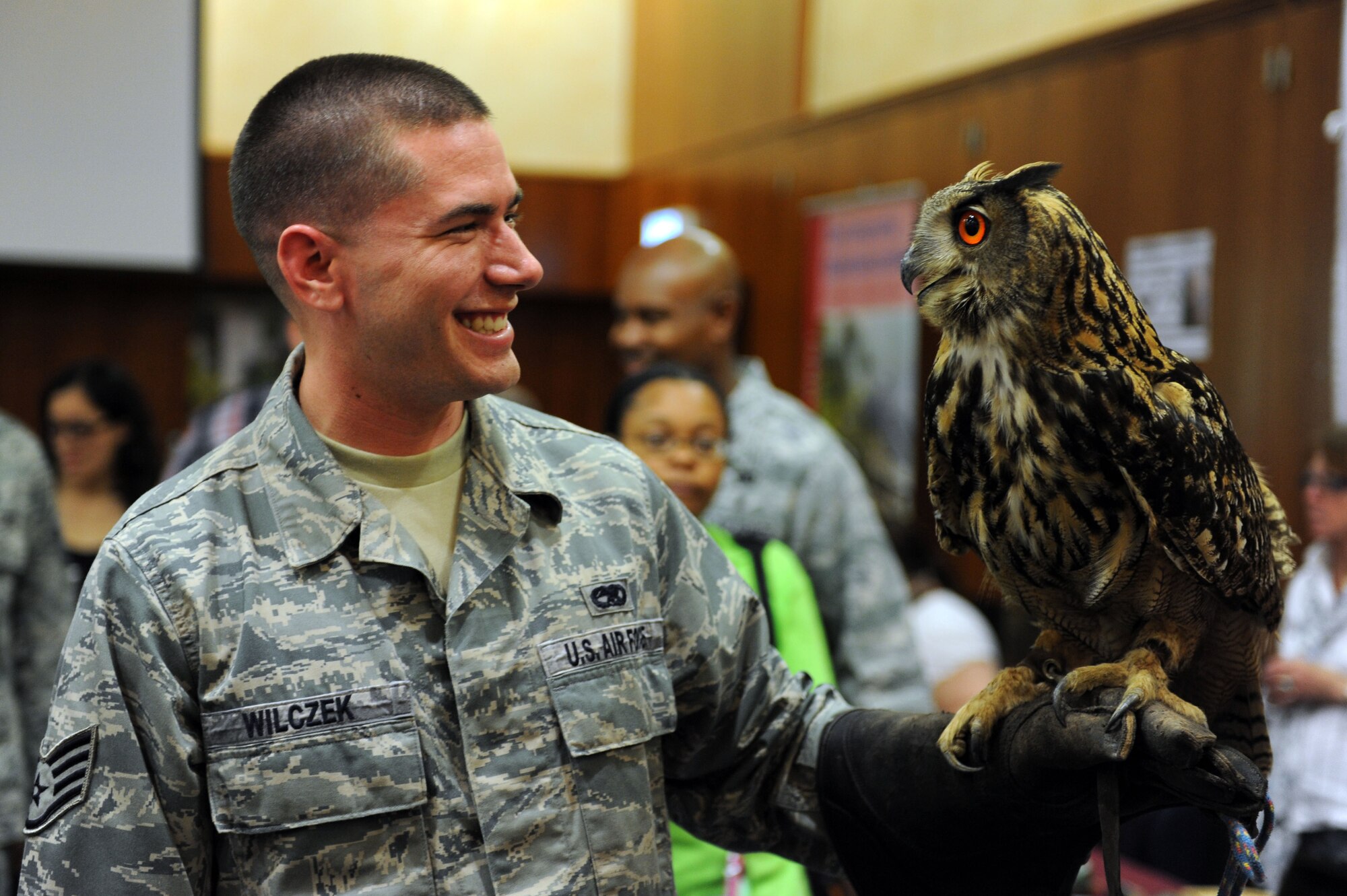 SPANGDAHLEM AIR BASE, Germany – Staff Sgt. Matthew Wilczek, 52nd Equipment Maintenance Squadron, holds a Eurasian Eagle-Owl from the Eifel Park in Gondorf during the seventh annual Explore the Eifel fair at Club Eifel here May 11. The event had more than 200 exhibitors from Germany, Belgium and Luxembourg providing travel information on hiking trips and hot-air balloon rides, prizes, free samples, wine tastings, and more. This event gave attendees the chance to sign up for tours and adventures taking place May 18-20 in the Eifel area. (U.S. Air Force photo by Senior Airman Christopher Toon/Released)