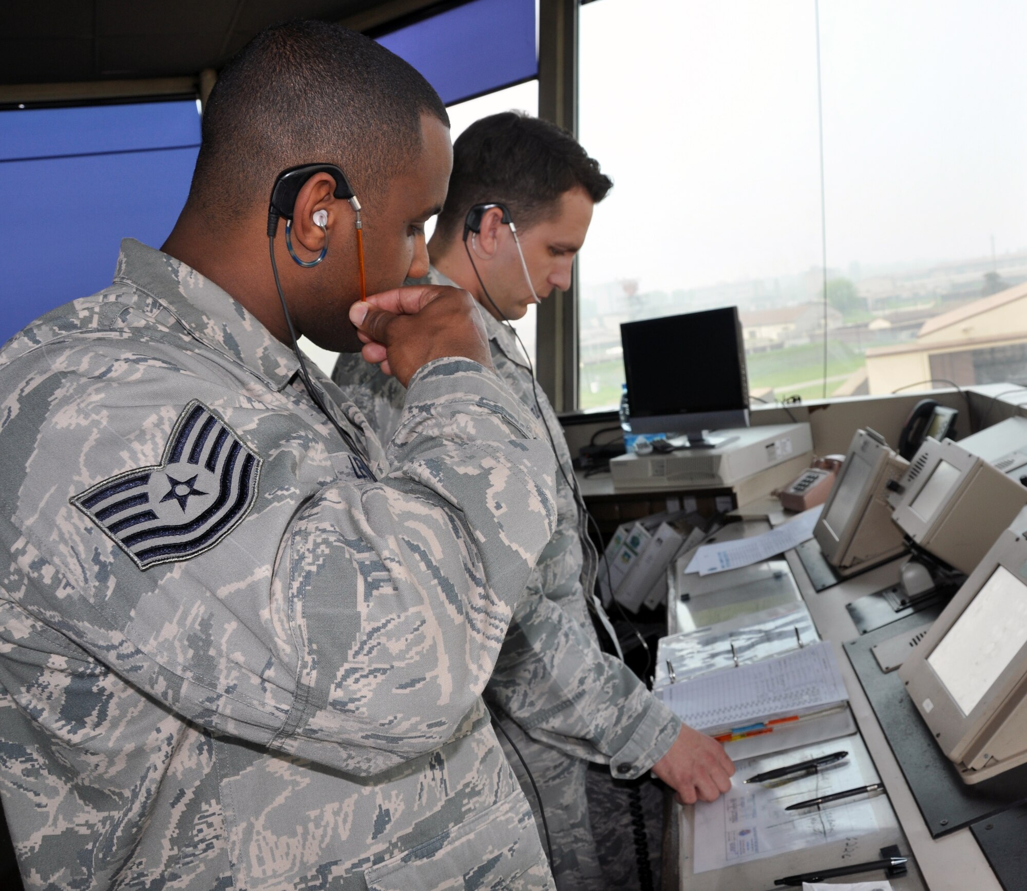 Tech. Sgt. Marcus Levias and Senior Airman Kevin Voelz, both 51st Operations Support Squadron air traffic controllers, talk to a pilot about his flight path at Osan Air Base, Republic of Korea, May 9, 2012. (U.S. Air Force photo/Airman 1st Class Michael Battles)