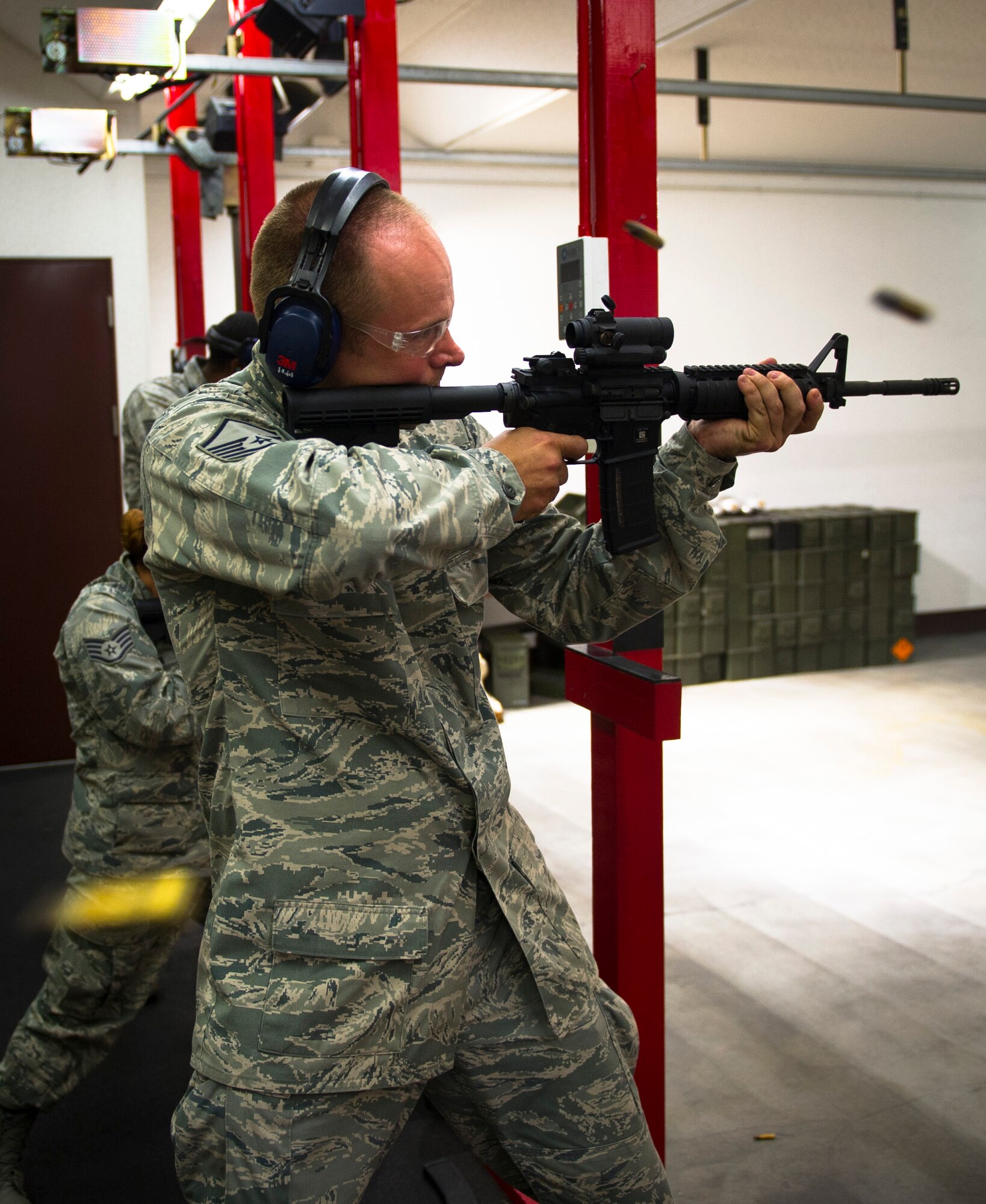 YOKOTA AIR BASE, Japan -- Master Sgt. Lance Backman, 374th Force Support Squadron fitness section chief, fires on three-round burst mode with an M4 rifle during weapons qualification May 10, 2012, at Yokota Air Base, Japan. In order to qualify, Airmen shoot approximately 196 rounds from several different positions. (U.S. Air Force photo by Staff Sgt. Chad C. Strohmeyer)