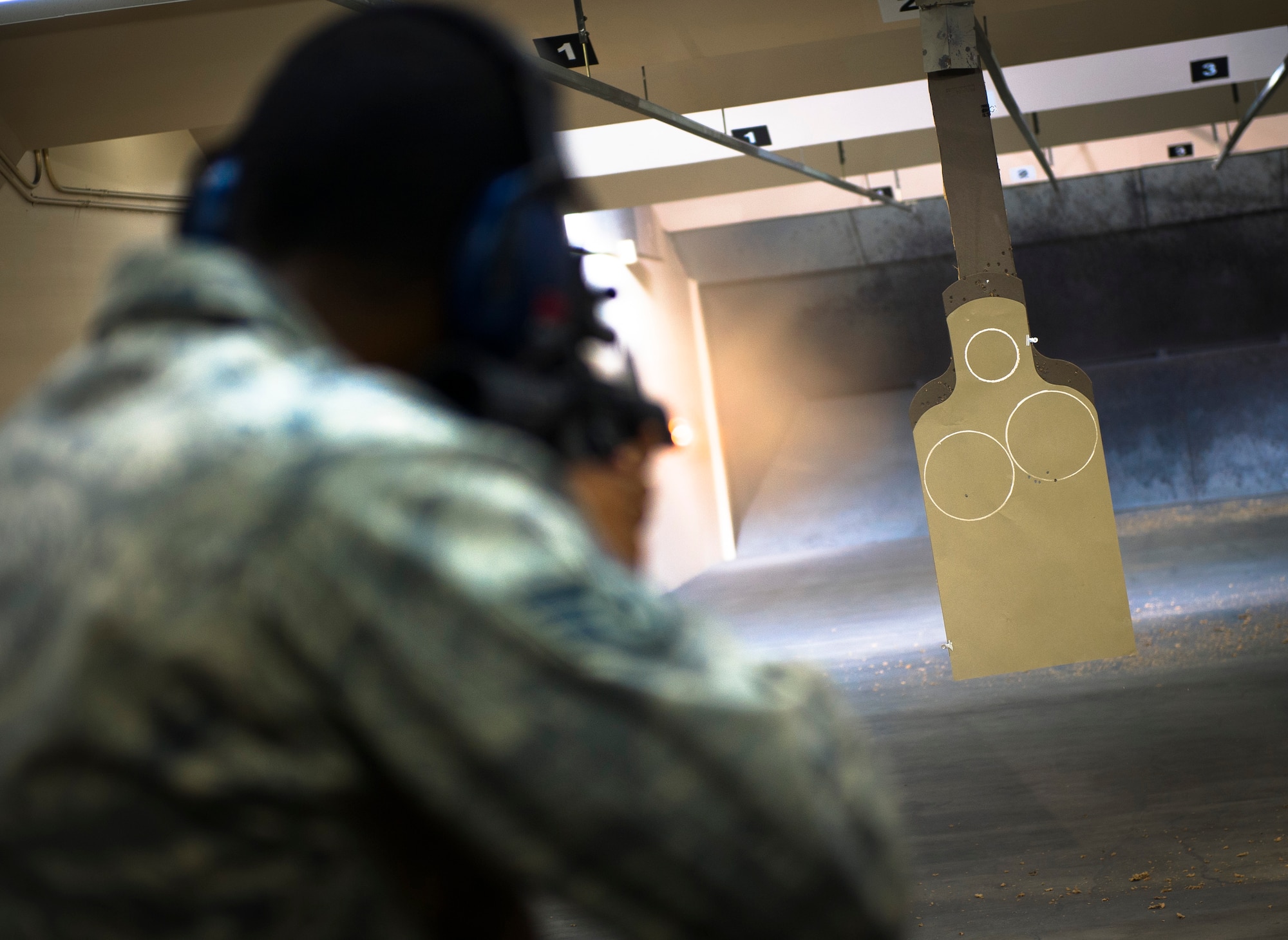 YOKOTA AIR BASE, Japan -- Staff Sgt. Ljavar Fludd-Moss, 374th Communications Squadron radio frequency transmissions specialist, fires at a paper target with an M4 rifle during weapons qualification May 10, 2012, at Yokota Air Base, Japan.  In addition to the current qualification measures, Airmen are also tested on their movement and three-round burst skill. (U.S. Air Force photo by Staff Sgt. Chad C. Strohmeyer)