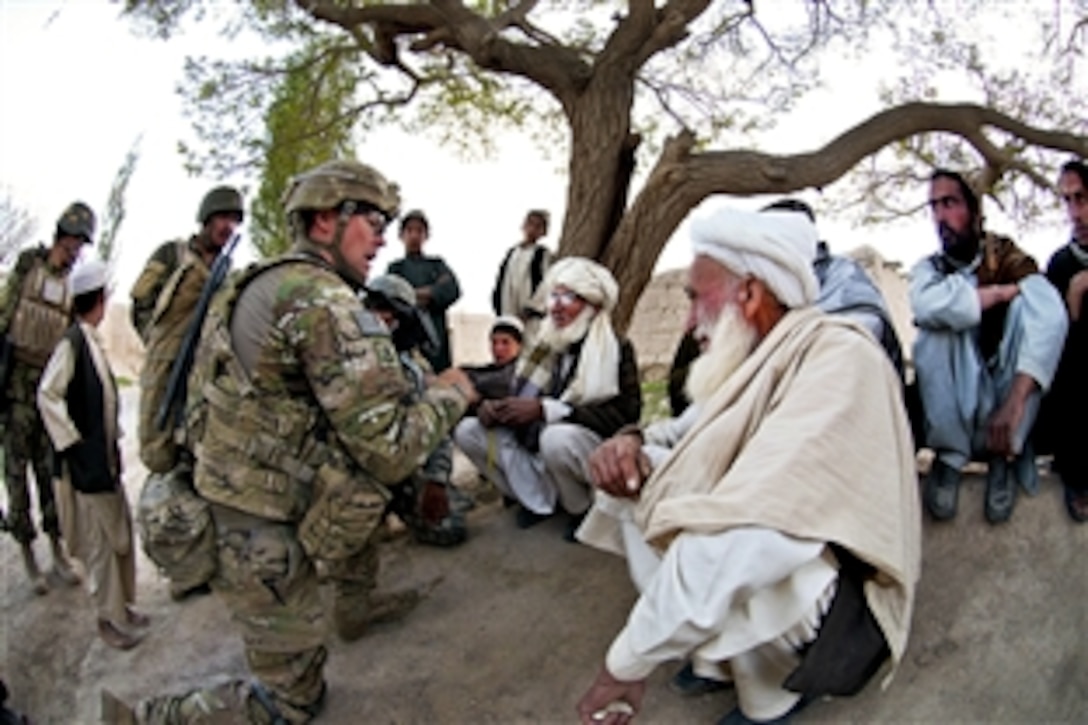 U.S. Army Sgt. 1st Class Scott Shepro, left kneeling, meets with village elders during a foot patrol in Afghanistan's southern Ghazni province, May 8, 2012. Shepro, a platoon sergeant, is assigned to the 82nd Airborne Division’s Company C, 2nd Battalion, 504th Parachute Infantry Regiment, 1st Brigade Combat Team.