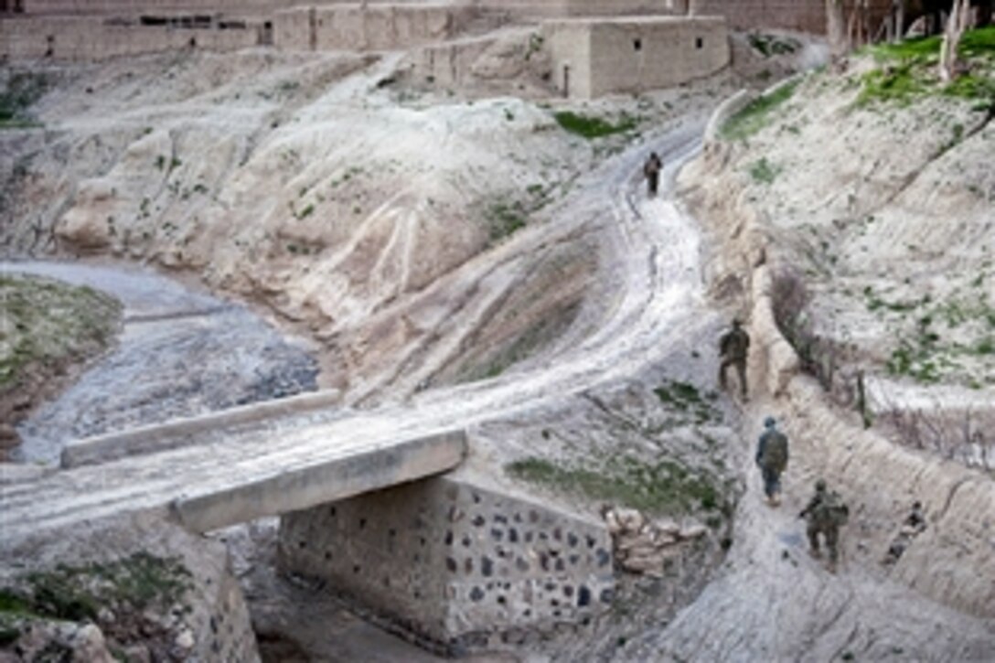 U.S. Army paratroopers and Afghan soldiers move along a riverbed during a foot patrol in Afghanistan's southern Ghazni province, May 8, 2012.