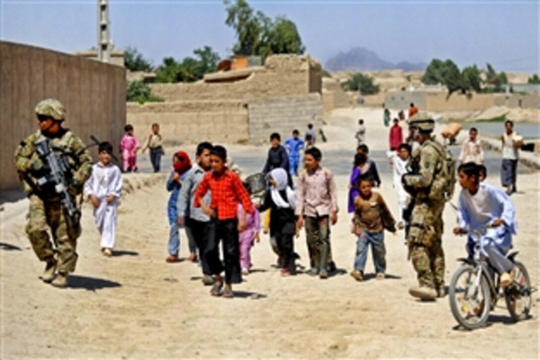 Children gather as members of Provincial Reconstruction Team Farah pull security during a mission in Farah City in Afghanistan's Farah province, May 12, 2012.