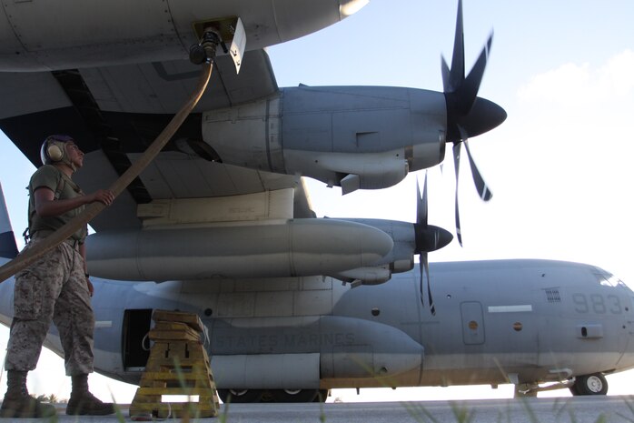 A bulk fuels specialist with Marine Wing Support Squadron 171, Marine Aircraft Group 12, unloads the fuel resupply from a KC-130J, May 15, during Exercise Geiger Fury 2012. The Marines, currently deployed to the island of Tinian, have a chance to test all systems and procedures in an expeditionary environment.