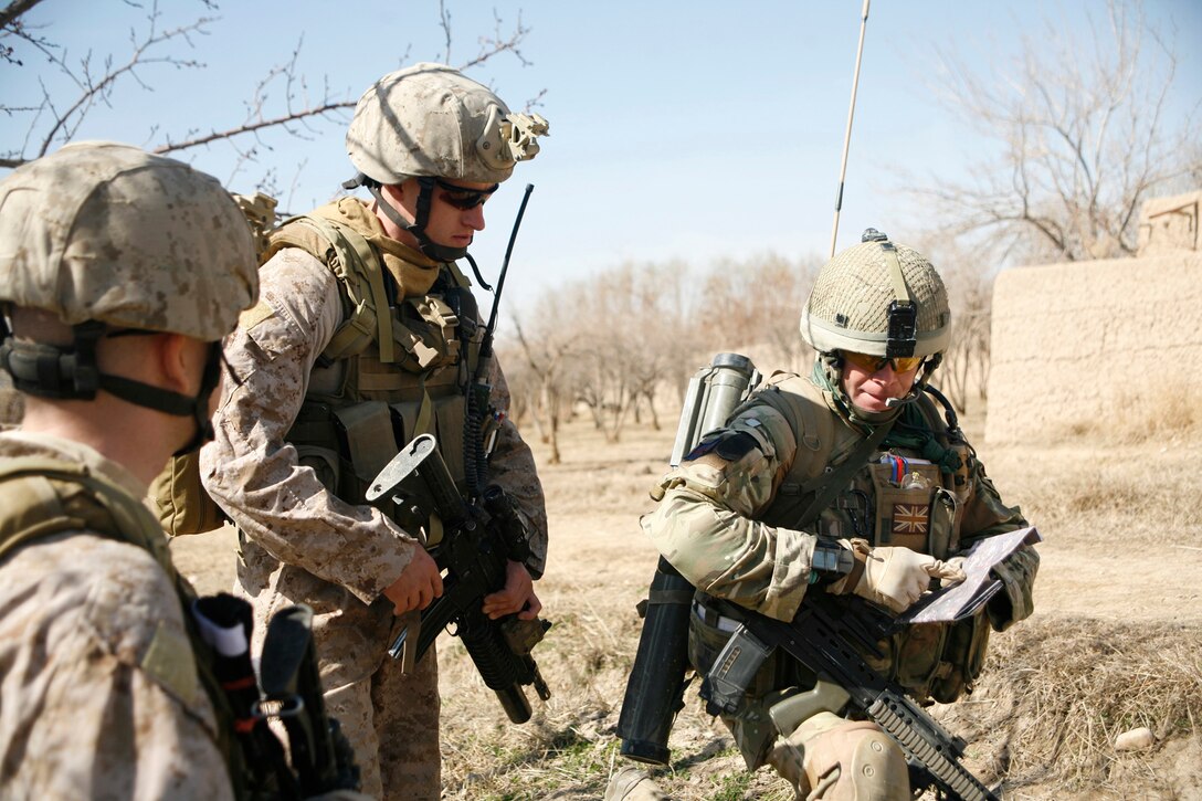 Sgt. Bradley Smith (far left), from Shawnee, Okla., a scout observer with 2nd Air Naval Gunfire Liaison Company, I Marine Expeditionary Force (Forward), looks on as Staff Sgt. Vincent Bartczak, a Cleveland native and joint tactical air controller with 2nd ANGLICO, discusses a patrol route with British Army Maj. Matt Collins, a Windsor, England, native and kandak commander advisor for the 1st Battalion Irish Guard’s Brigade Advisory Group, during Operation Omid Shash, Feb. 17, in Gereshk, Helmand province, Afghanistan. Second ANGLICO Marines and sailors have been supporting several U.S. and coalition units in Helmand province with their unique ability to coordinate tactics on the ground with aviation and other supporting arms assets since arriving in Afghanistan in November. During Omid Shash, 2nd ANGLICO Marines provided coalition and Afghan National Army units maneuvering through the area of operation access to virtually any aviation asset “on station” for intelligence gathering or, if need arose, decisive firepower to defeat Taliban insurgents.