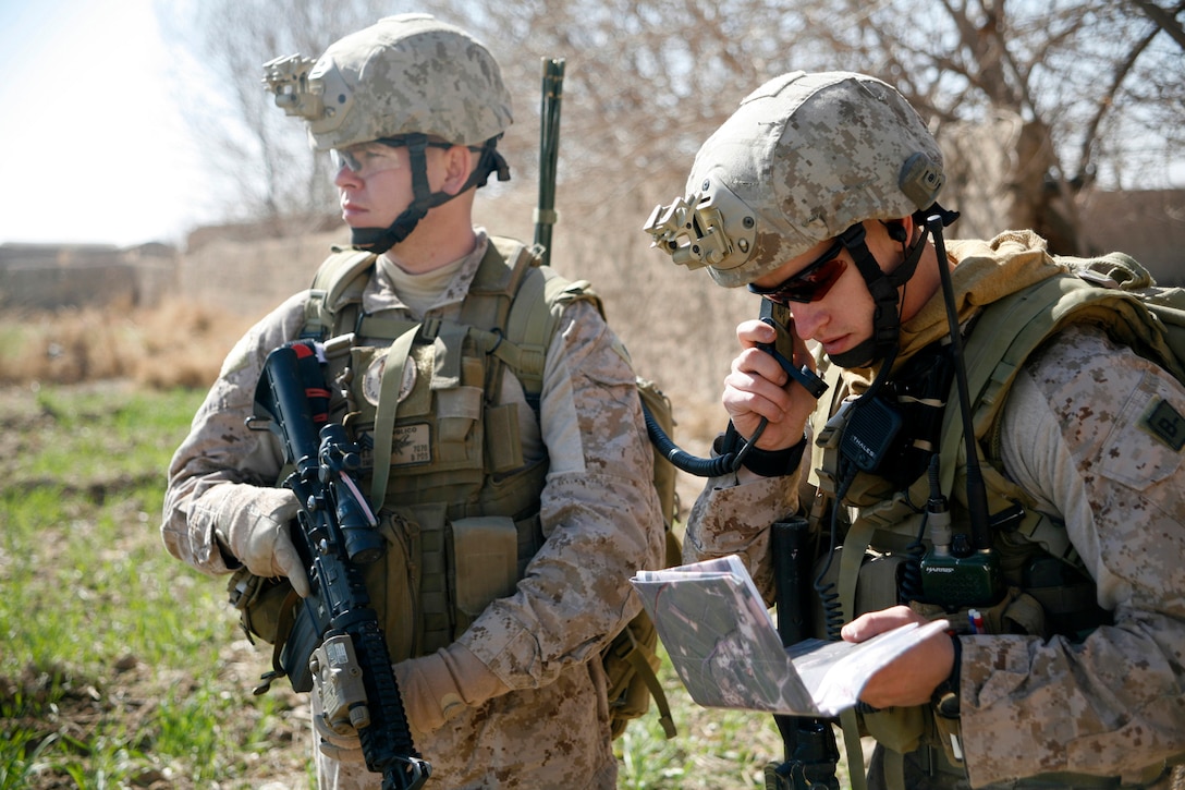 Sgt. Bradley Smith (far left), from Shawnee, Okla., a scout observer with 2nd Air Naval Gunfire Liaison Company, I Marine Expeditionary Force (Forward), looks on as Staff Sgt. Vincent Bartczak, a Cleveland native and joint tactical air controller with 2nd ANGLICO, discusses a patrol route with British Army Maj. Matt Collins, a Windsor, England, native and kandak commander advisor for the 1st Battalion Irish Guard’s Brigade Advisory Group, during Operation Omid Shash, Feb. 17, in Gereshk, Helmand province, Afghanistan. Second ANGLICO Marines and sailors have been supporting several U.S. and coalition units in Helmand province with their unique ability to coordinate tactics on the ground with aviation and other supporting arms assets since arriving in Afghanistan in November. During Omid Shash, 2nd ANGLICO Marines provided coalition and Afghan National Army units maneuvering through the area of operation access to virtually any aviation asset “on station” for intelligence gathering or, if need arose, decisive firepower to defeat Taliban insurgents.