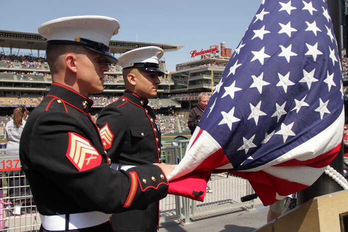Recruiting Substation Woodbury's Sgt. Adam Kruse, 26, from Huron, S.D., and Sgt. Julio Gonzalez, 25, from Los Angeles, raise the American flag for Peace Officers Memorial Day at Target Field May 15. Marines from Recruiting Substation Roseville also participated in the ceremony. The flag was also flown at Metropolitan Stadium more than 25 years ago. For additional imagery from the event, visit www.facebook.com/rstwincities.