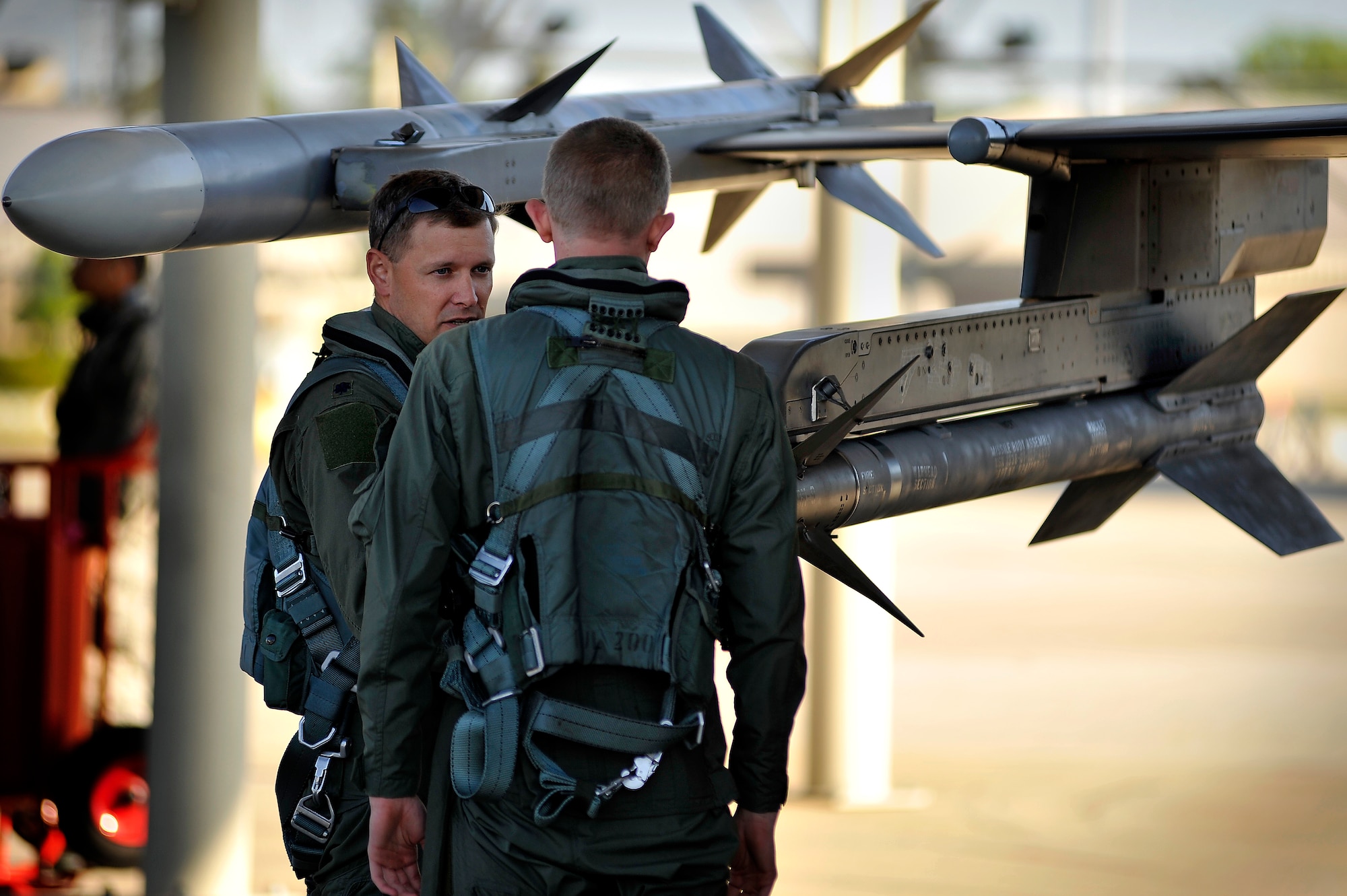 U.S. Air Force Lt. Col. Scott Walker, F-16 Fighting Falcon pilot and chief of safety, talks with ROTC Cadet Jacob Moore during a pre-flight inspection of his F-16 Fighting Falcon, April 13, 2012, Shaw Air Force Base, S.C. Shaw's F-16 fleet is the number one asset that aids pilots when providing combat-ready airpower anytime, anywhere. (U.S. Air Force photo by Senior Airman Kenny Holston/Released)


