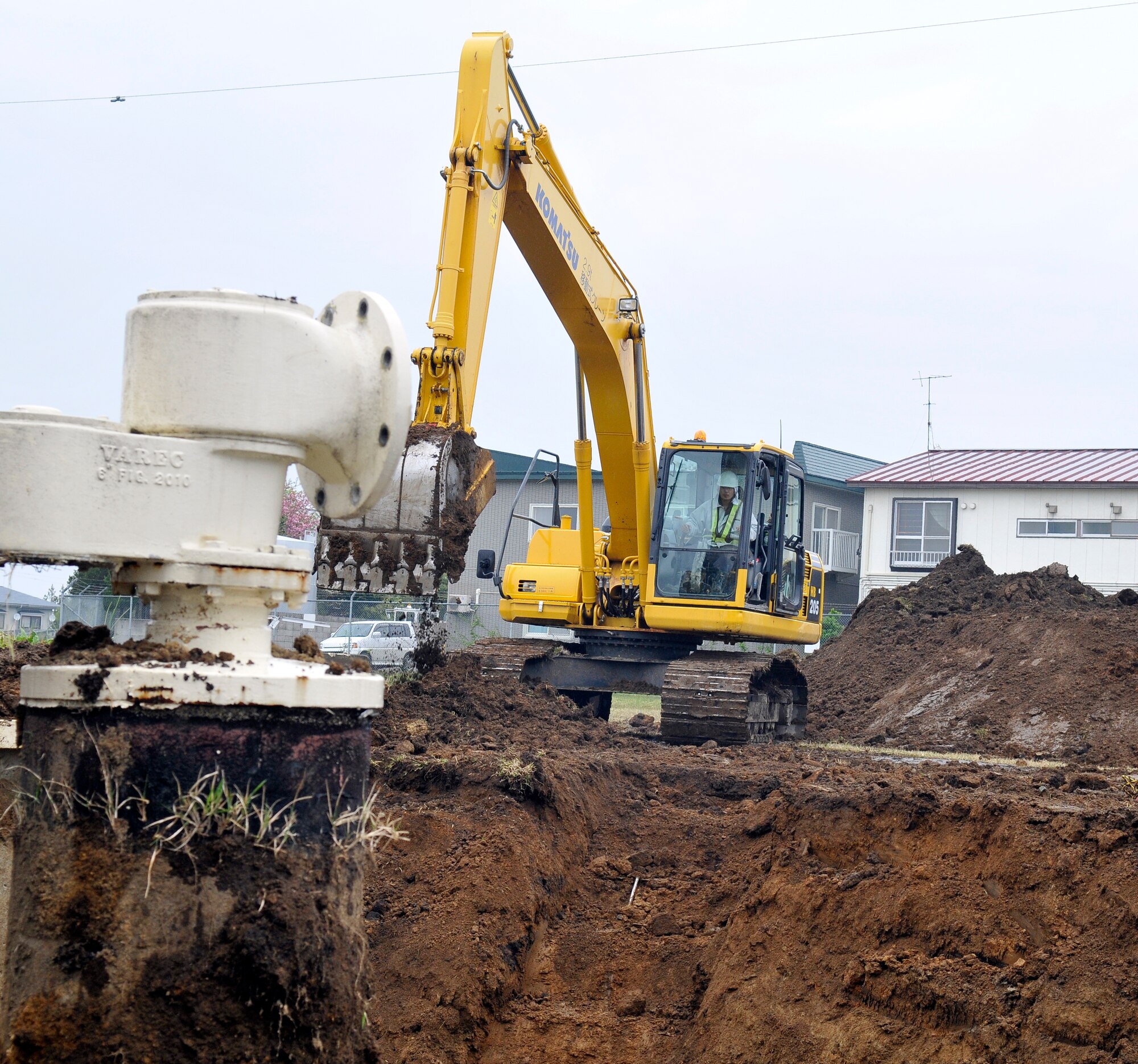 A track hoe removes a pile of dirt from a fuel tank at Misawa Air Base, Japan May 15, 2012. The 35th Civil Engineer Squadron, in concert with the Defense Logistics Agency, are removing five fuel tanks from Tank Farm 1. This project is scheduled to be completed in September of 2012. (U.S. Air Force photo by Tech. Sgt. Phillip Butterfield/Released)