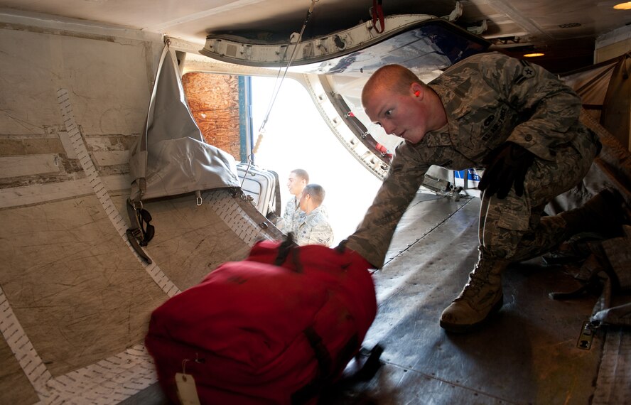 Airman 1st Class Caleb Burker, 28th Aircraft Maintenance Squadron weapons load crew member, loads luggage into a commercial aircraft prior to leaving for Green Flag, a combat training exercise at Nellis Air Force Base, Nev., on the flightline at Ellsworth AFB, S.D., May 10, 2012. For some of the Airmen participating in the exercise, Green Flag will be the final exercise before actually deploying to Southwest Asia later this year. (U.S. Air Force photo by Airman 1st Class Kate Thornton/Released)