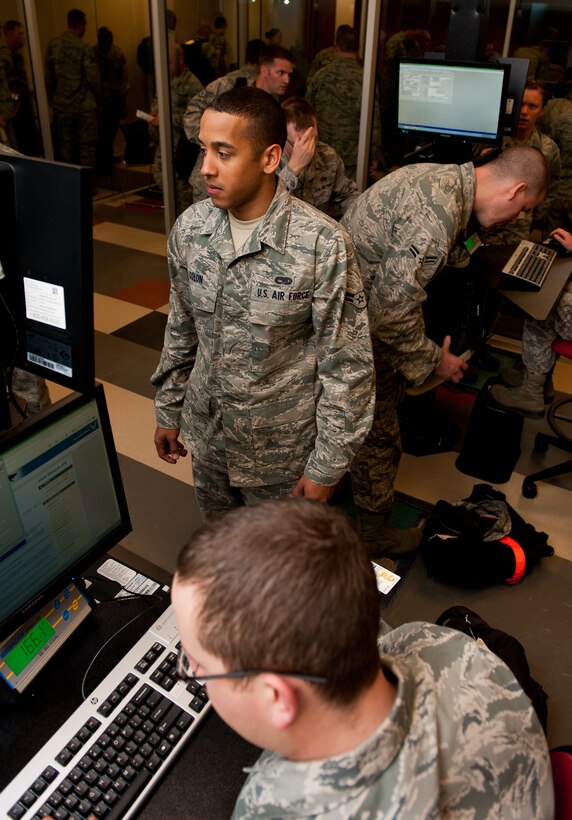 Ellsworth Air Force Base, S.D., Airmen confirm their personal information prior to leaving for Green Flag, a combat training exercise at Nellis Air Force Base, Nev., in the deployment center at Ellsworth AFB, S.D., May 10, 2012. Ellsworth’s new deployment center hosts computer based filing systems for Airmen managing the deployment processing line to enter, change, and verify deployers’ important information. (U.S. Air Force photo by Airman 1st Class Kate Thornton/Released)
