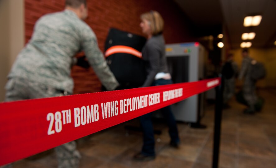 A security cordon separates the transportation safety administration equipment and augmented personnel from Airmen processing through security in preparation to leave for Green Flag, a combat training exercise at Nellis Air Force Base, Nev., in the deployment center at Ellsworth AFB, S.D., May 10, 2012. Ellsworth’s new deployment center streamlines the deployment process with a variety of upgrades, equipment and redesigned flow through the system. (U.S. Air Force photo by Airman 1st Class Kate Thornton/Released)