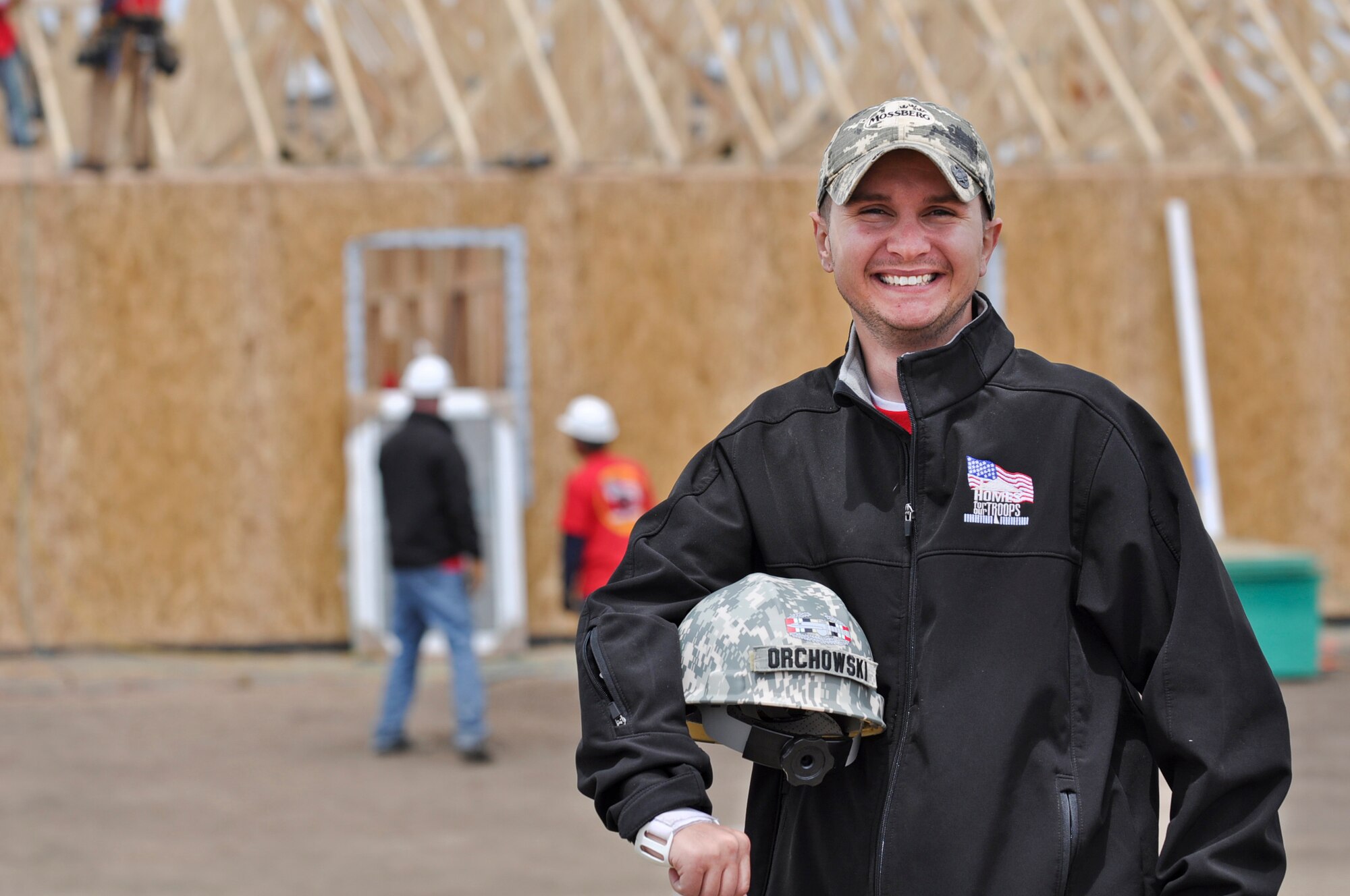 PARKER, Colo. -- Nick Orchowski, an injured Operation Iraqi Freedom combat veteran, poses for a photo as volunteers work on his home May 11, 2012. Approximately 60 volunteers from Buckley Air Force Base, Colo. helped with the construction of Orchowski's new home. (U.S. Air Force photo by Senior Airman Christopher Gross)